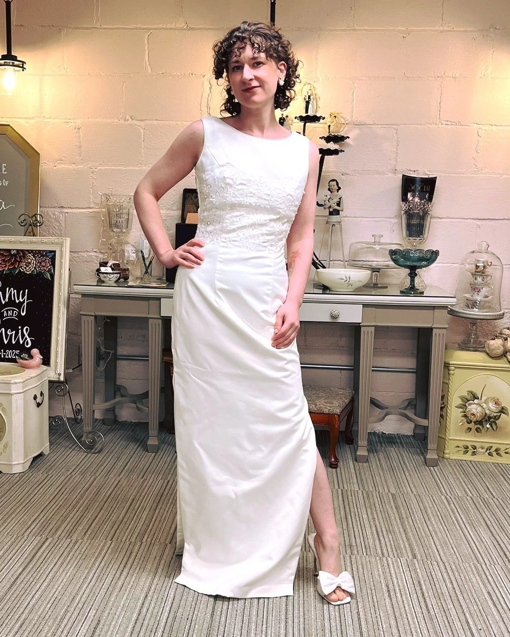 Wedding Wednesday! This is a 90's satin gown including a gorgeous detachable train with scalloped edging. Beautiful embroidery as well! #brideonabudget #weddingwednesday #kismetmoment #kismetconsignment #kismet #90svintage #vintagebridal