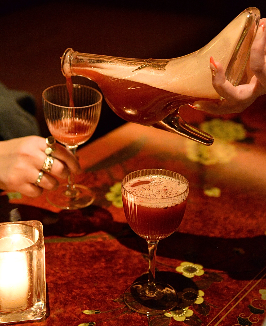 Late-night London nightclub with DJ spinning hits and guests dancing in Fitzrovia