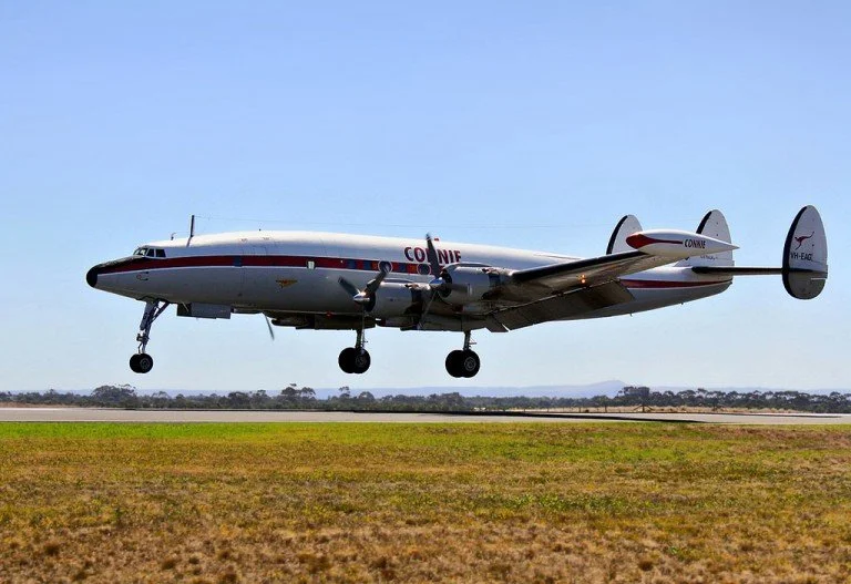  A preserved Super Constellation “Connie” comes in to land. The  long  nose-wheel and curved fuselage were designed to keep the longer propeller blades clear of the ground, whilst the triple lower tail enabled it to still be stored in the standard hangars of the day. 