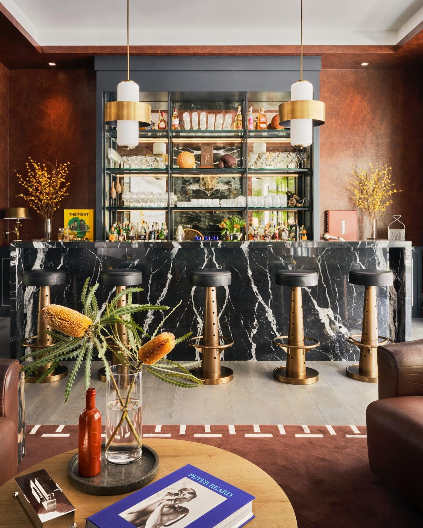 The Pub Room of a Bel Air home features vintage buffalo-hide lounge seating by de Sede, a custom TORREY rug by Stark Carpet, and bar stools by Blackman Cruz. 

Design by @torreyllc 
Photo by @manoloyllera