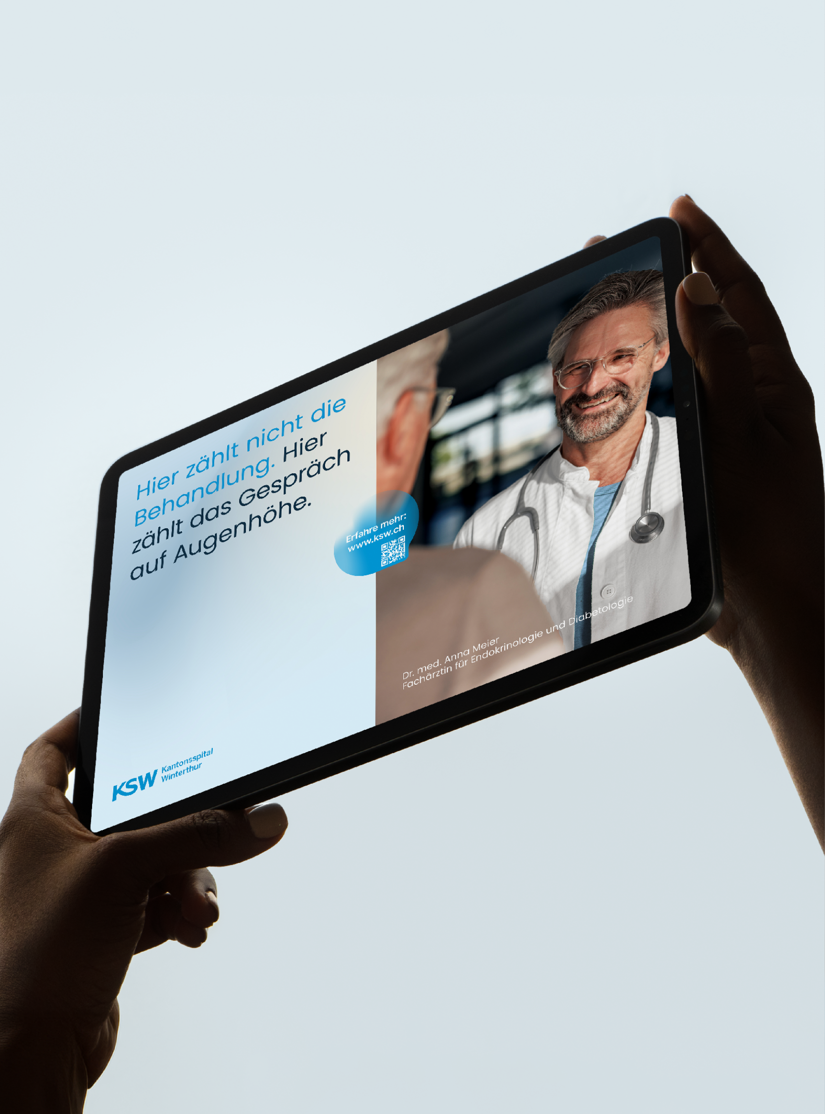 Person hält ein Tablet mit einem digitalen Bild eines Arztes in einem weißen Kittel und Brille, der lächelnd in die Kamera schaut.