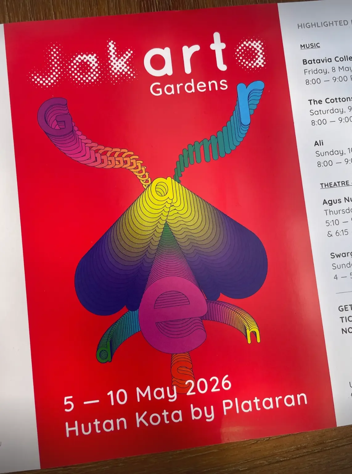 Art Jakarta Gardens 2026 event brochure showing the official poster with a colourful typographic butterfly illustration on a red background, dated 5–10 May 2026 at Hutan Kota by Plataran