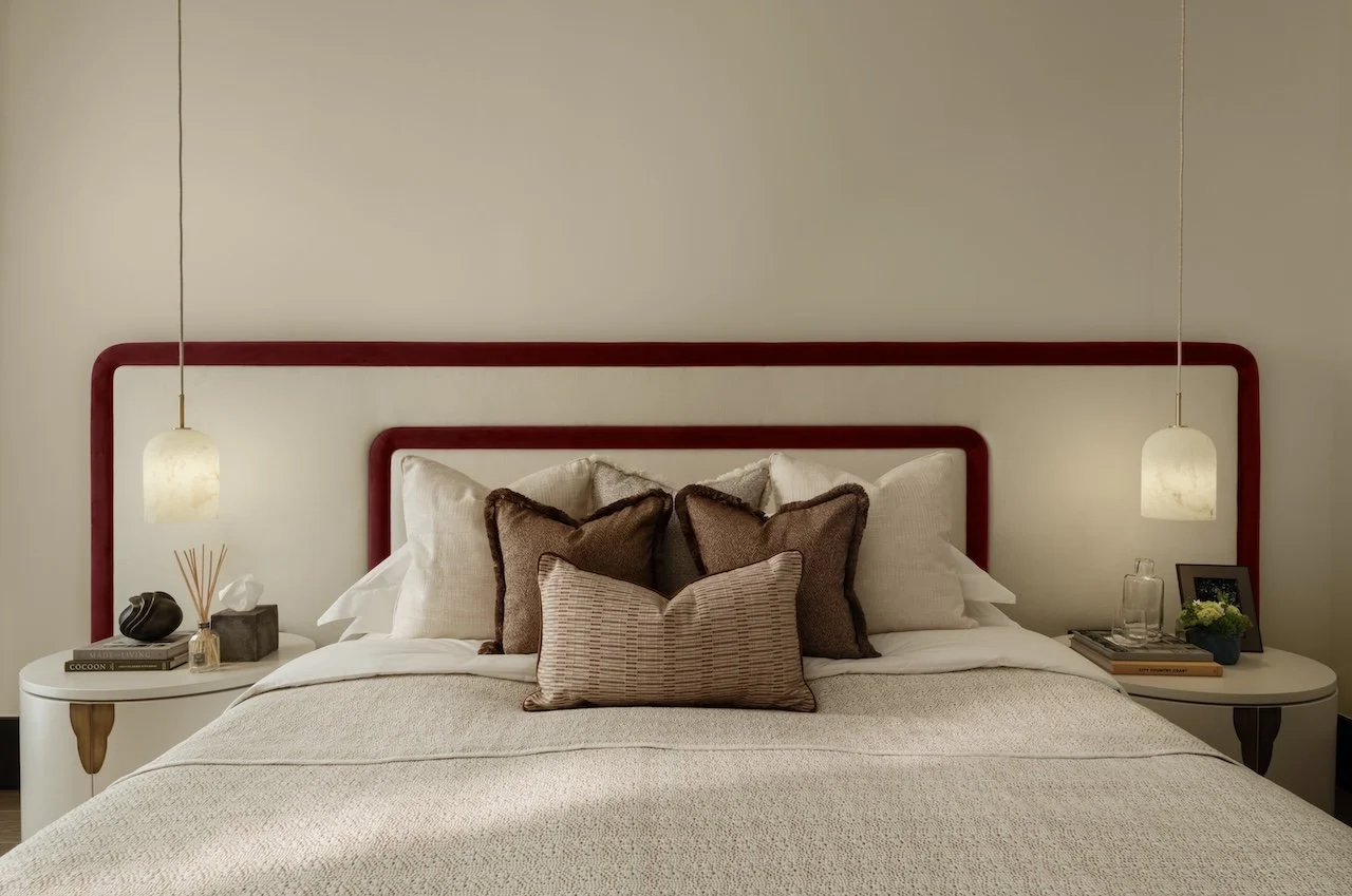 Luxury show home bedroom by Burbeck Interiors with bespoke headboard, designer lighting, premium furniture and elegant contemporary styling.