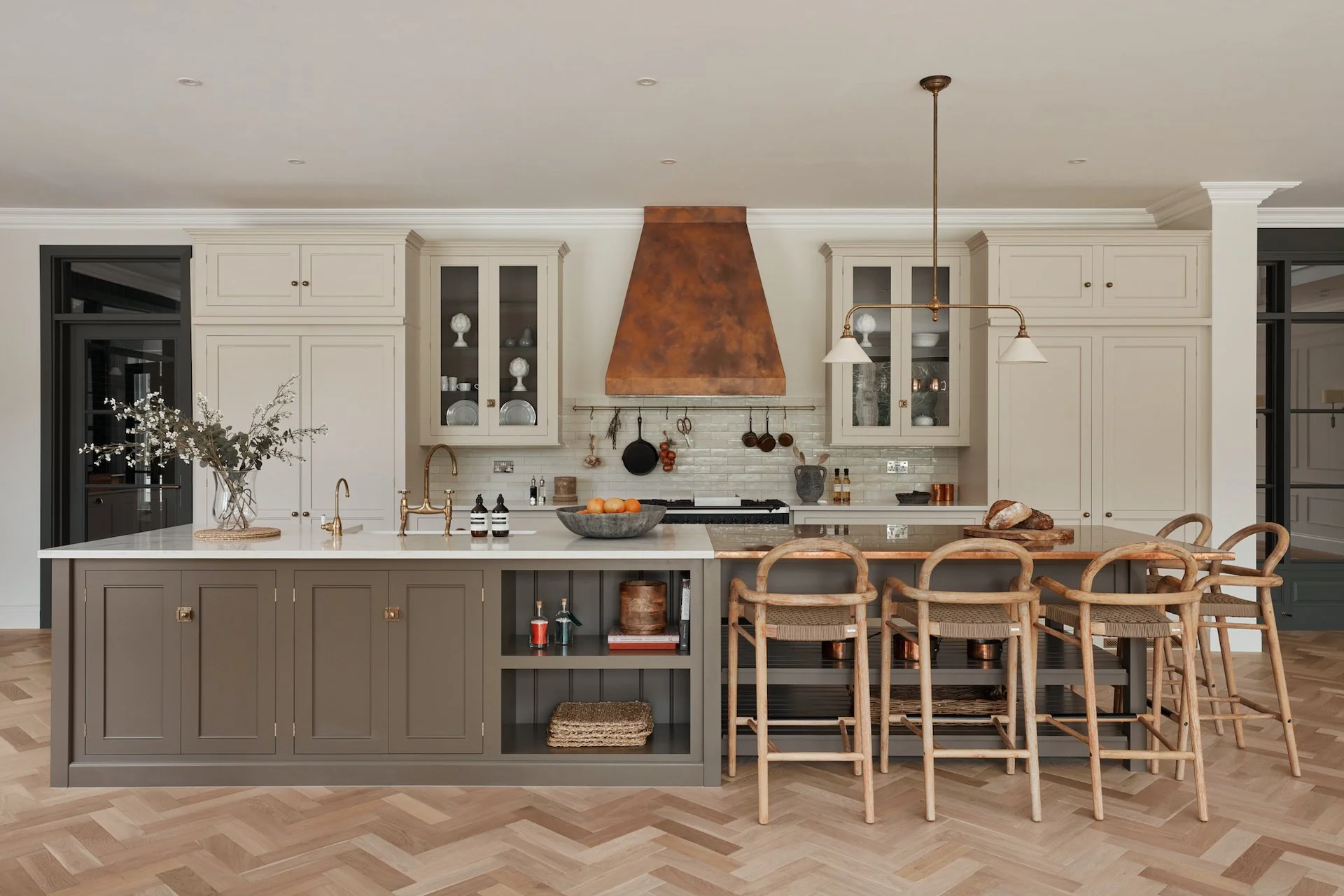 farm house style kitchen with island bar stool and copper hood