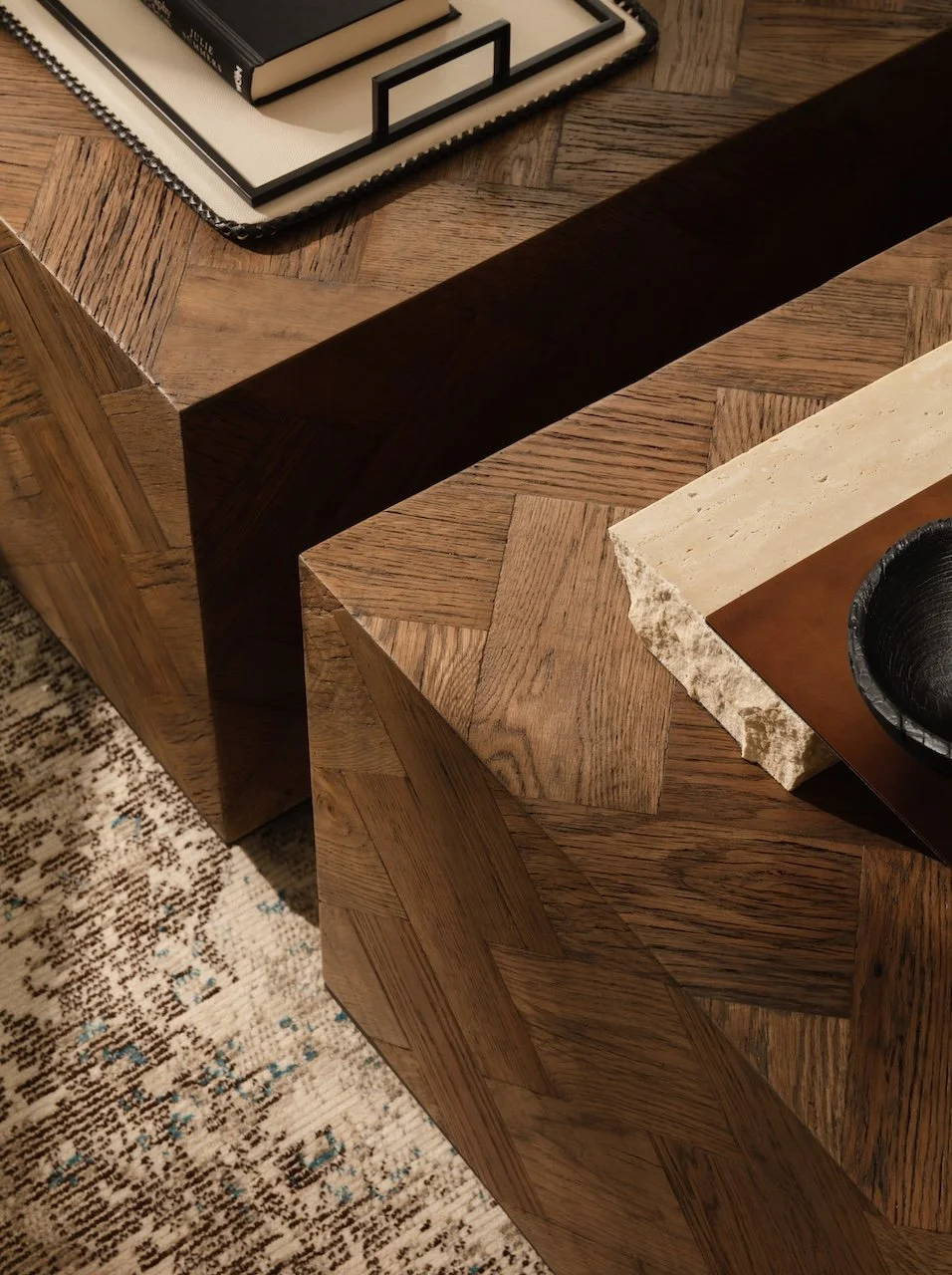 Designer parquet oak coffee tables featuring geometric wood grain detailing and luxury styling accessories. Premium contemporary furniture by Burbeck Interiors, ideal for interior design projects, home staging and luxury residential interiors.