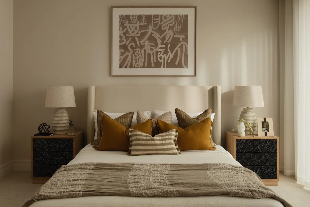 Elegant luxury bedroom design with a bespoke upholstered bed, designer bedside cabinets, layered cushions and statement table lamps. Premium interior design and furnishing by Burbeck Interiors.