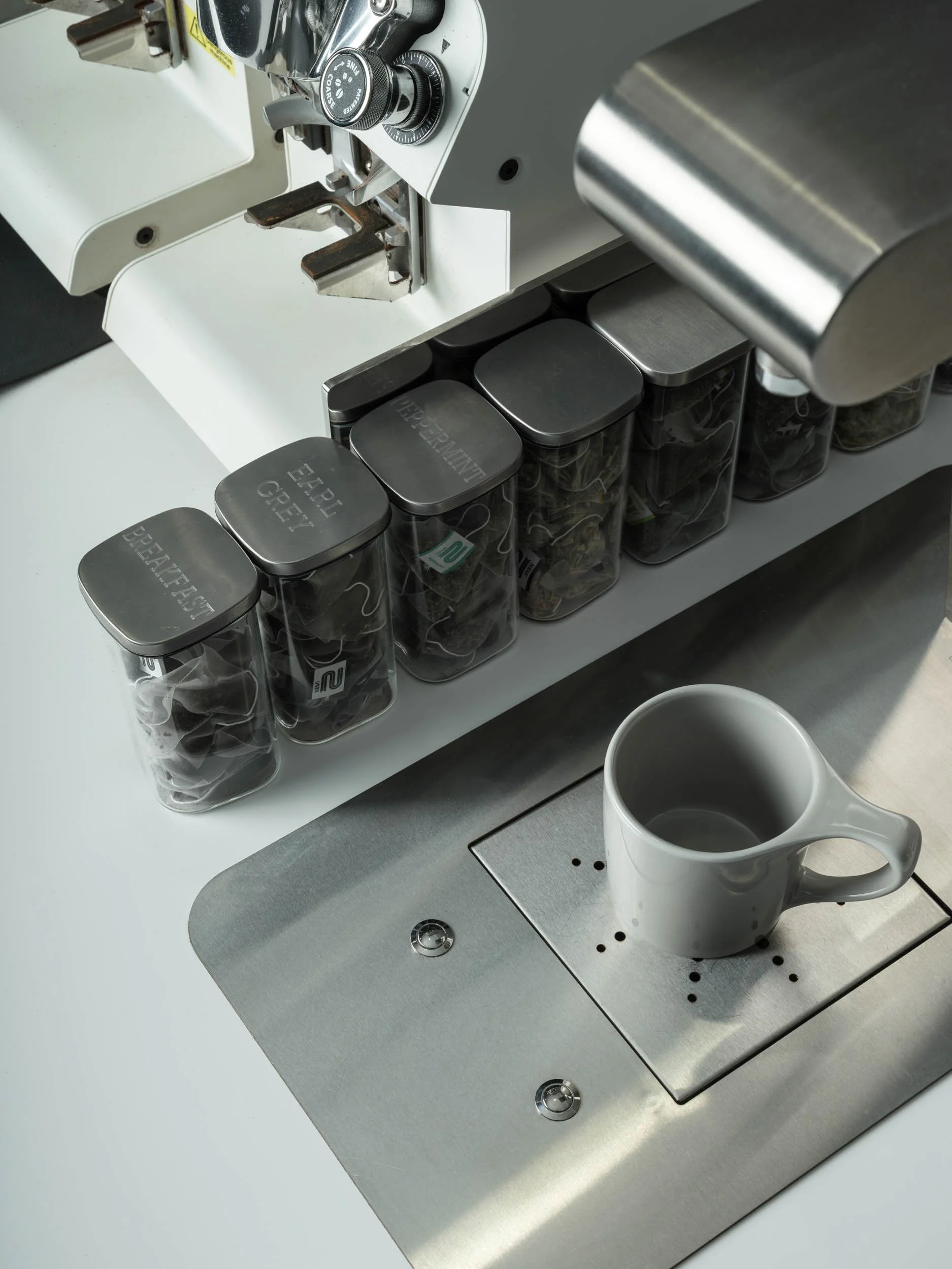 Tea making facility on white coffee counter, café interior photography, London