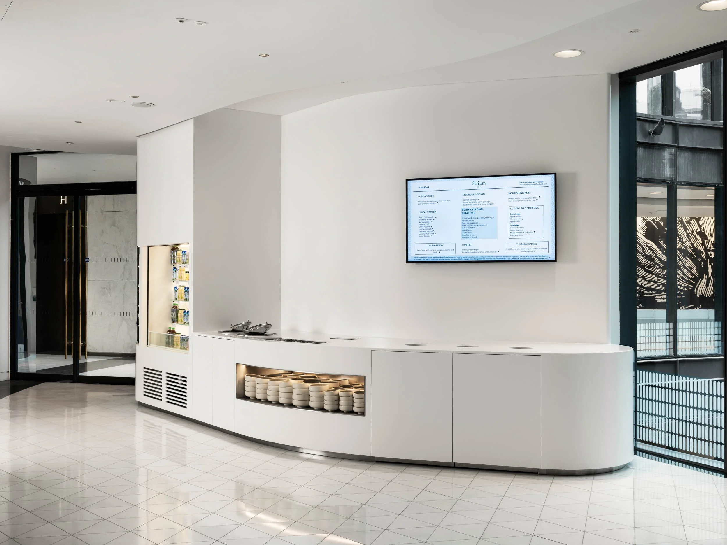 White curved serving counter in modern café interior, London