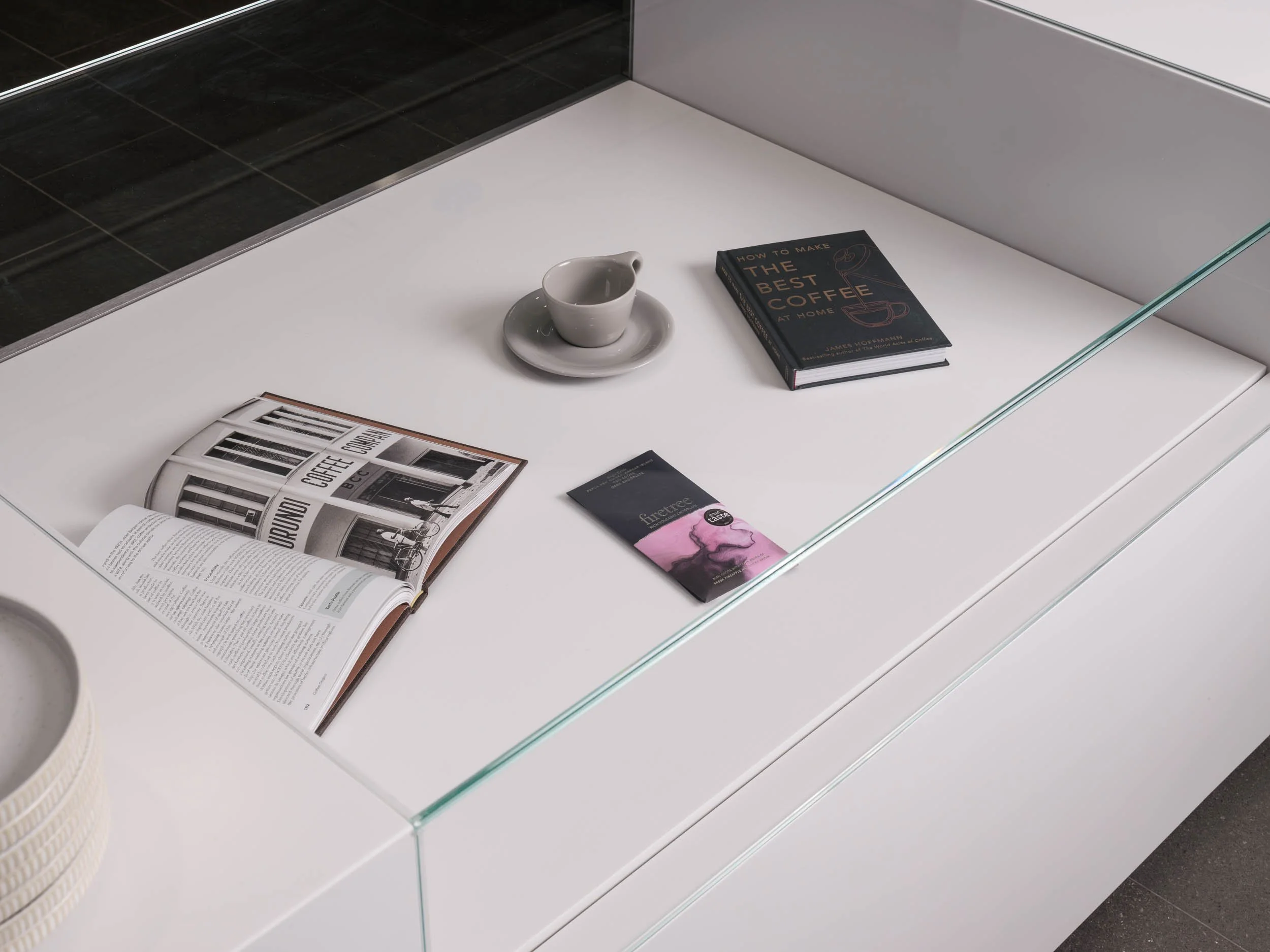 glass topped display counter with white base, café interior photography, London