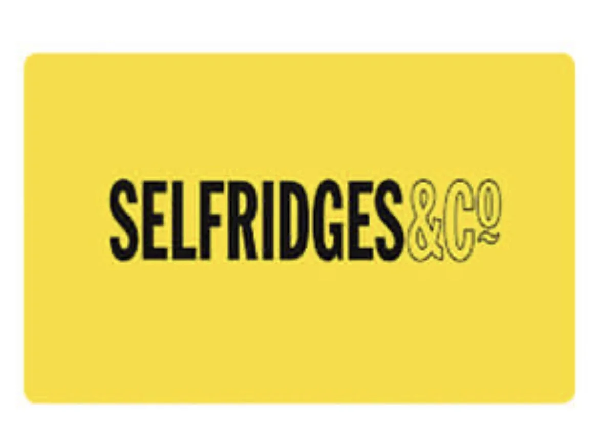 Yellow rectangular sign with black and yellow text reading "Selfridges & Co"