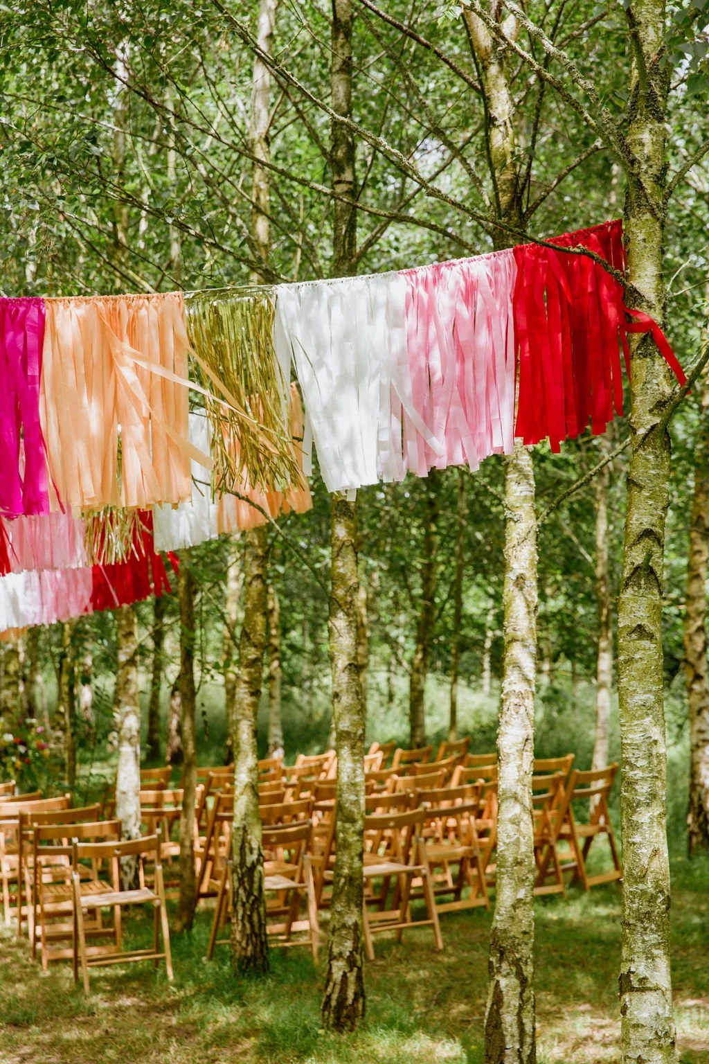 outdoor festival-theme wedding decorations in the wood at Higher Holcombe Devon