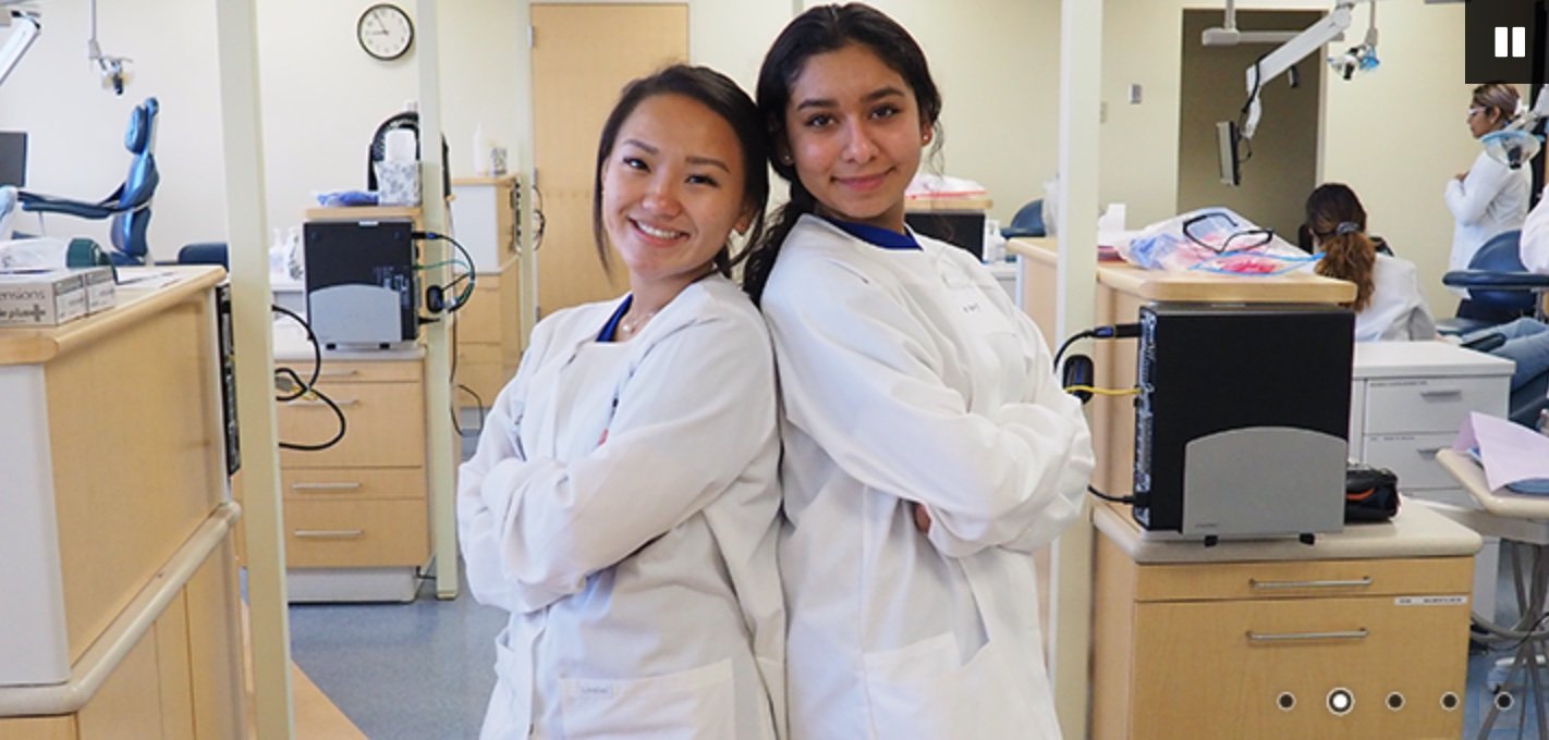 Two women students in lab coats