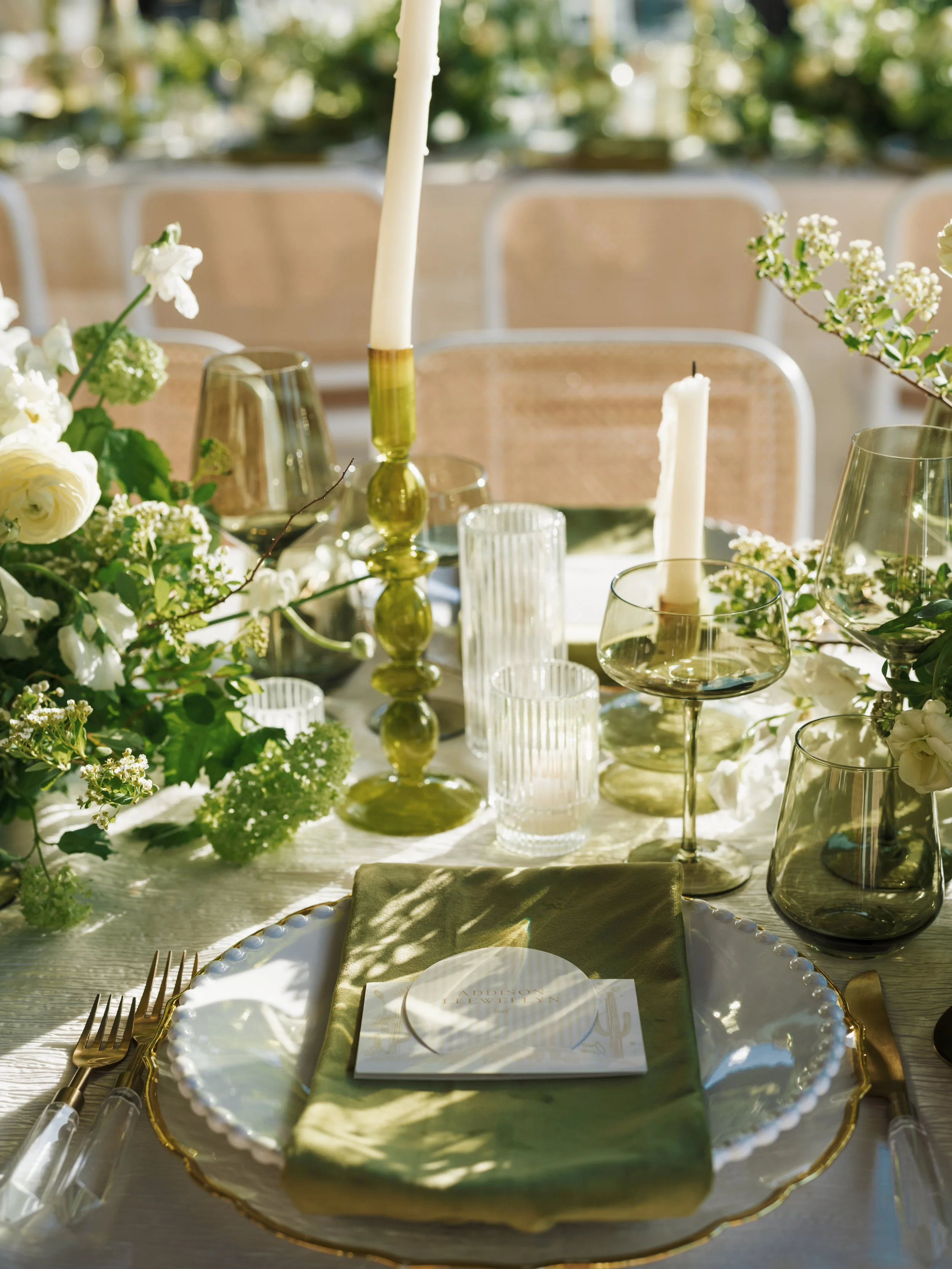 Close up of wedding table details featuring elegant floral arrangements, table settings, and decorative accents.