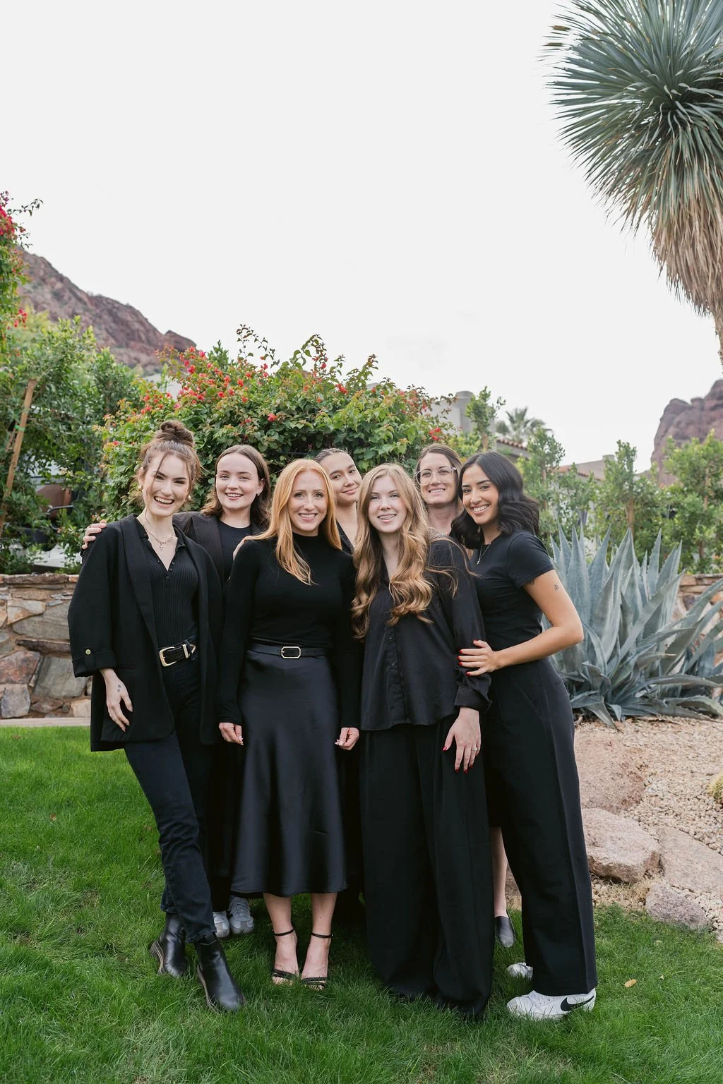group of girls in black posing for a photo