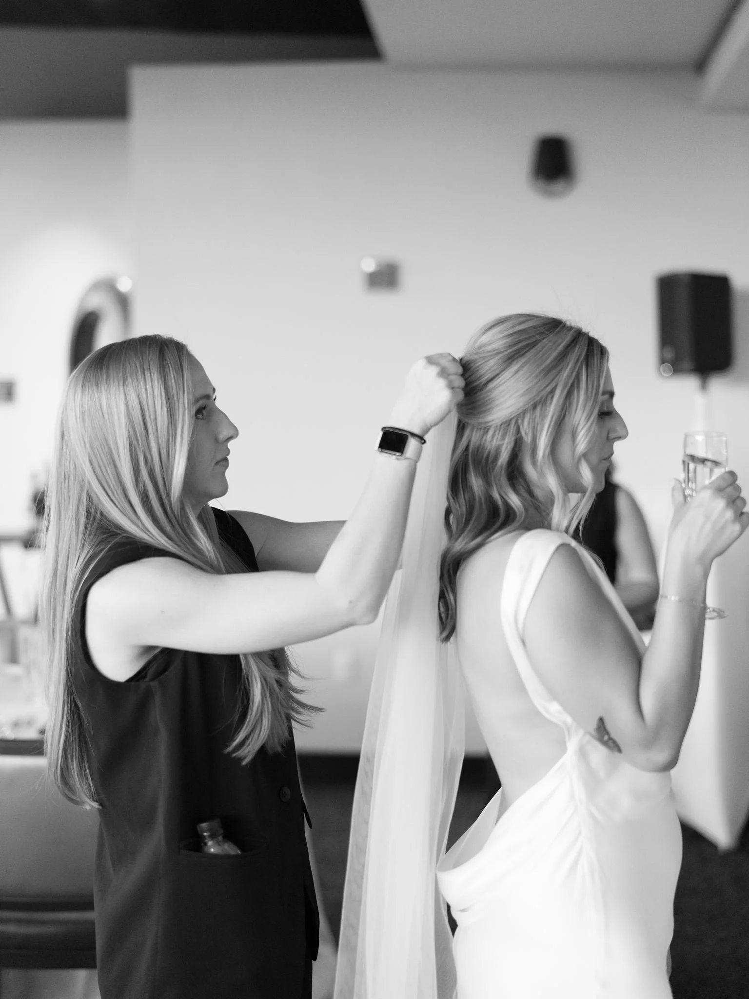 wedding planner putting in veil for bride in scottsdale arizona at the sanctuary camelback after a spring wedding