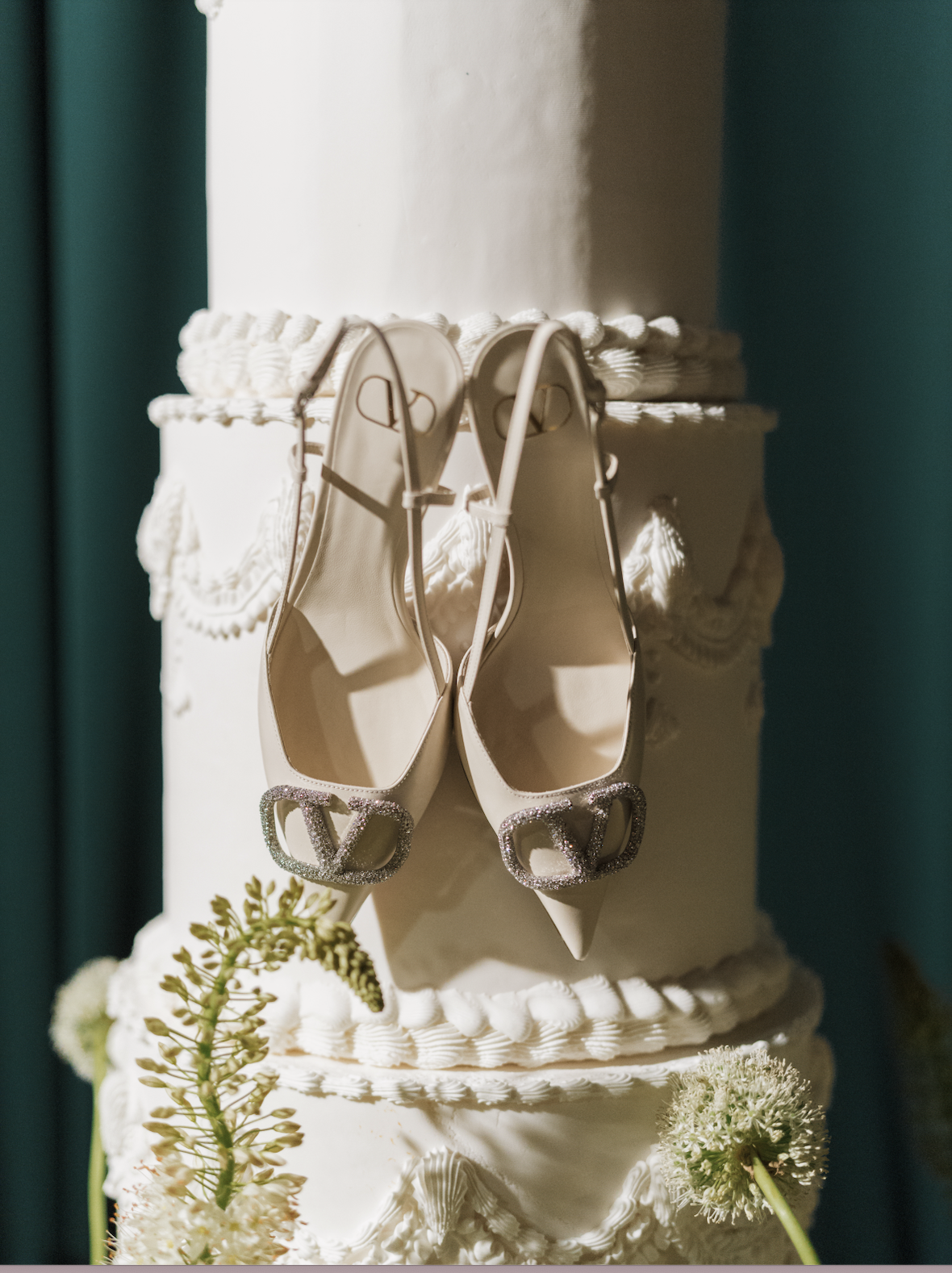 Close up of brides heels on the wedding cake.