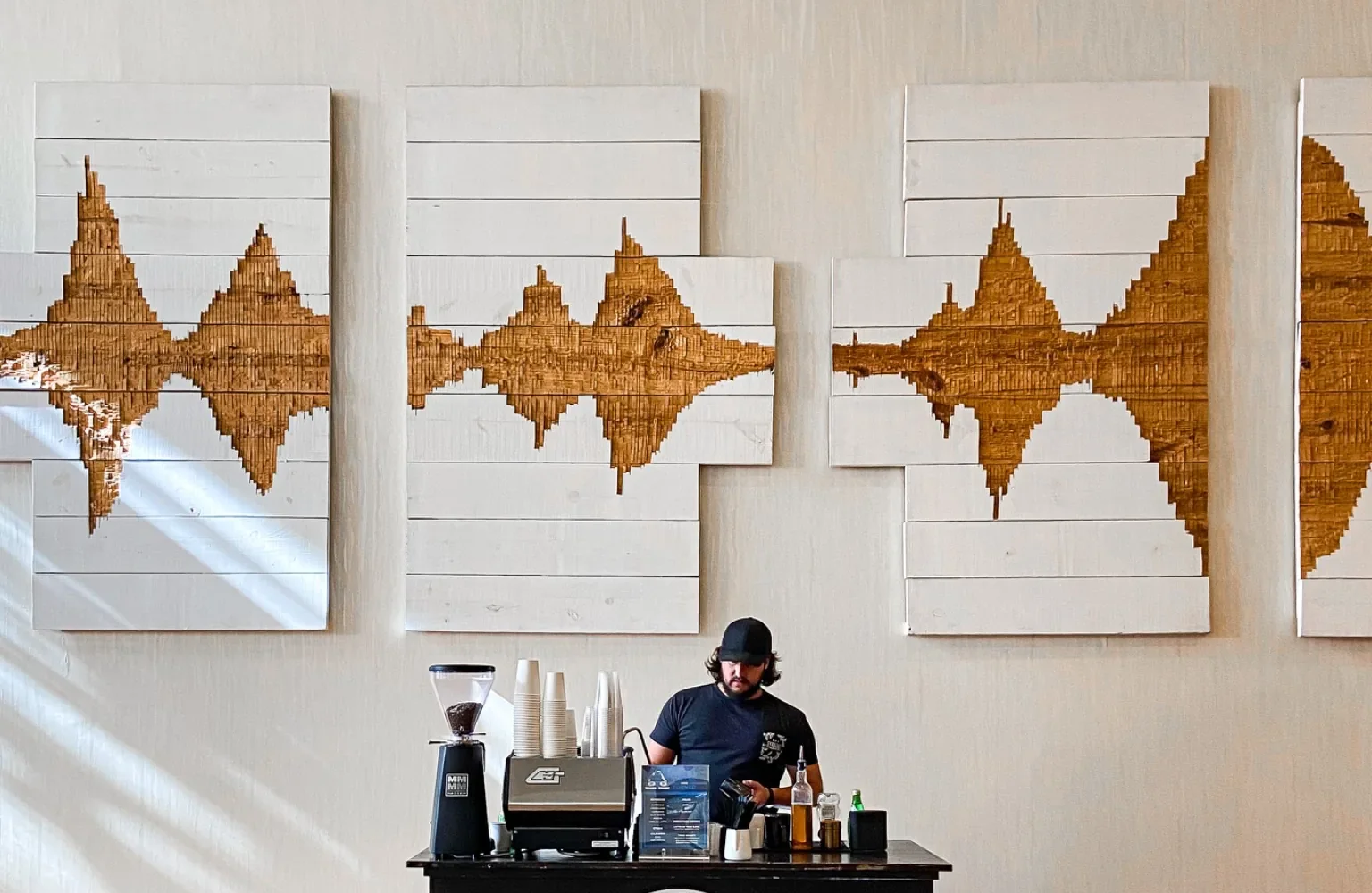 Mobile espresso cart setup with grinder, espresso machine, cups, and syrups for a Nashville event coffee service