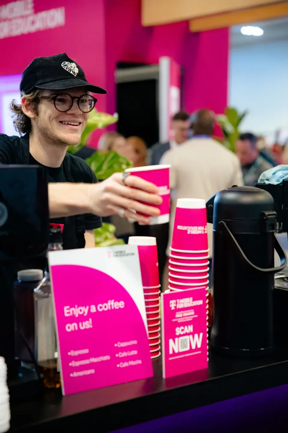 Barista handing out hot drip coffee for a high-volume batch brew station at a conference expo