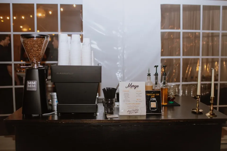 Elegant wedding coffee stand setup with espresso equipment and syrups — Merge Coffee Bar catering in Nashville