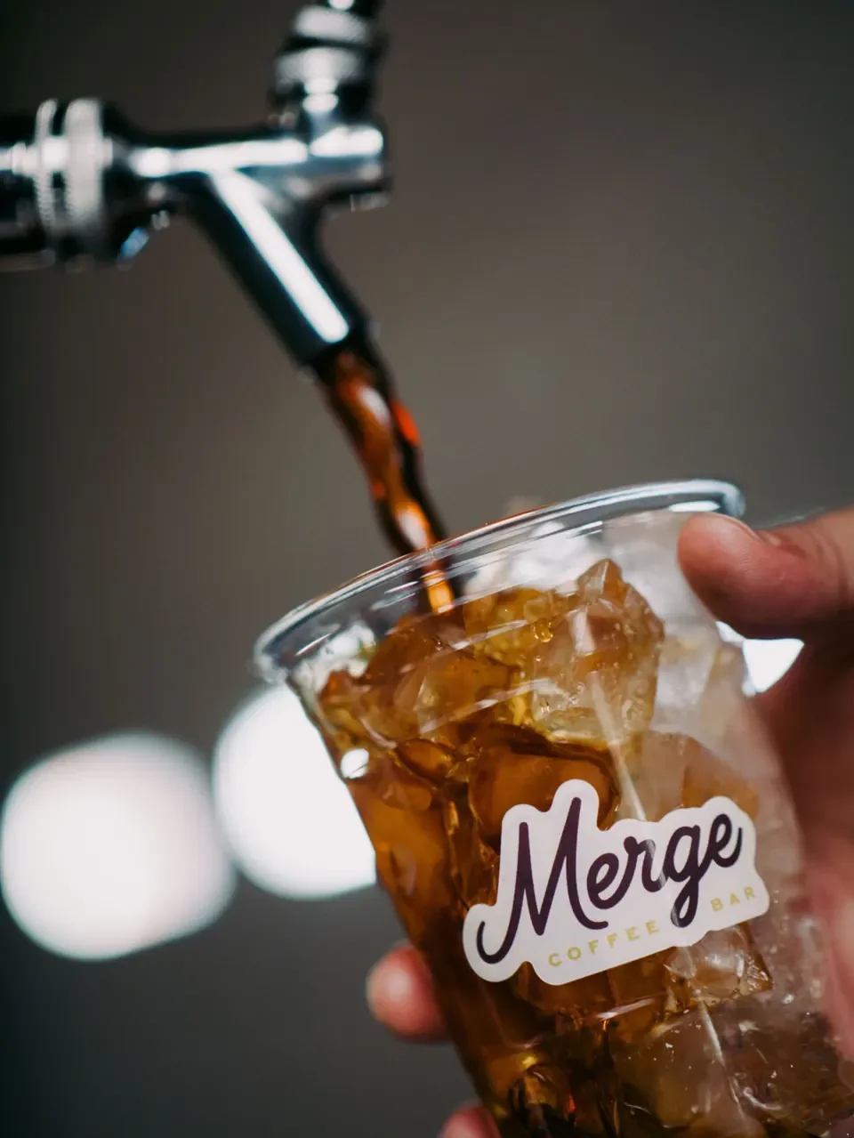 Cold brew on tap pouring into an iced cup — self-serve cold brew setup for offices and corporate kitchens