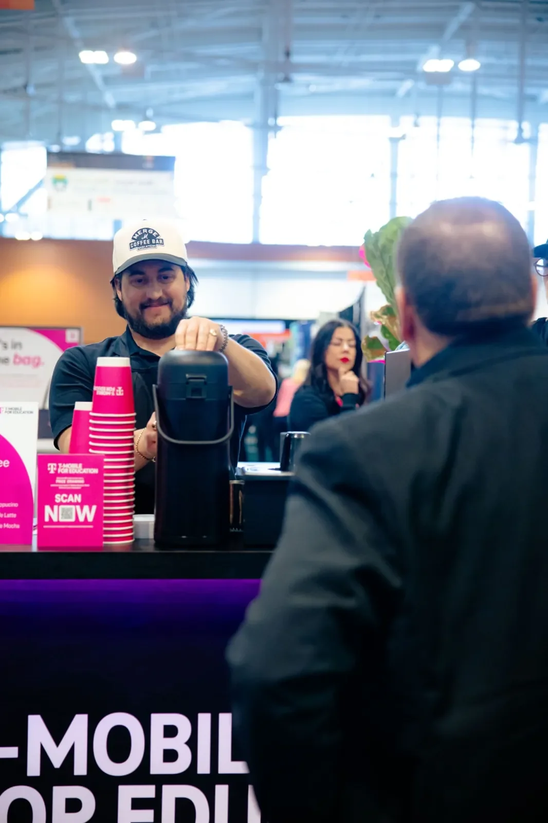 Merge Coffee Bar barista serving hot coffee for a corporate event coffee station