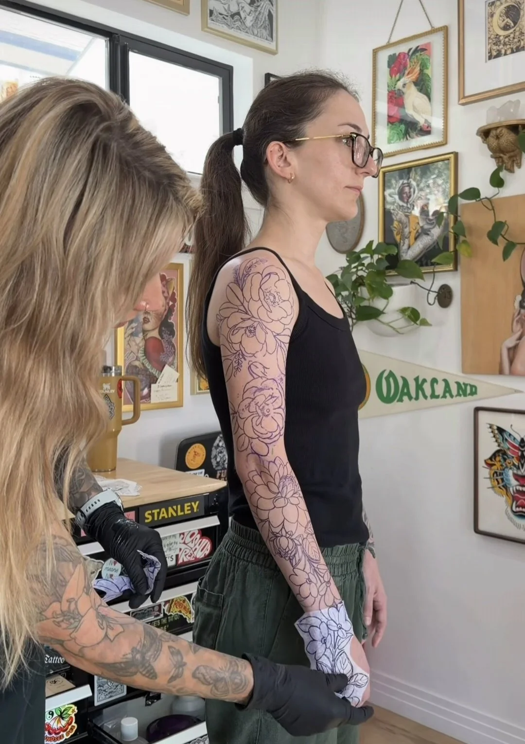 tattoo artist placing stencil