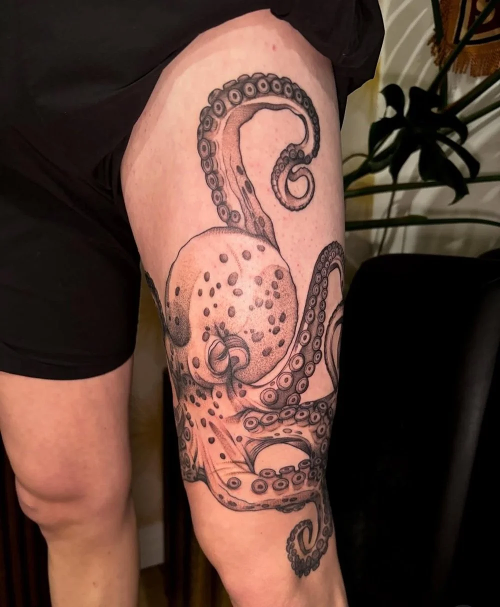 black and grey octopus sleeve tattoo featuring detailed tentacles and realistic shading, showcasing one of the best tattoo styles and their origins