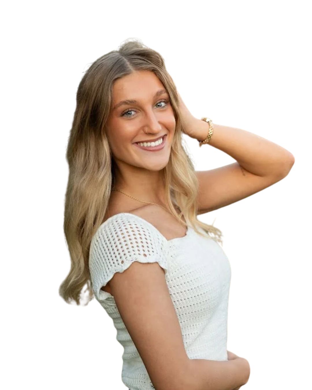 A young woman with long blonde hair, smiling, wearing a black sleeveless top and blue jeans, standing against a white background.