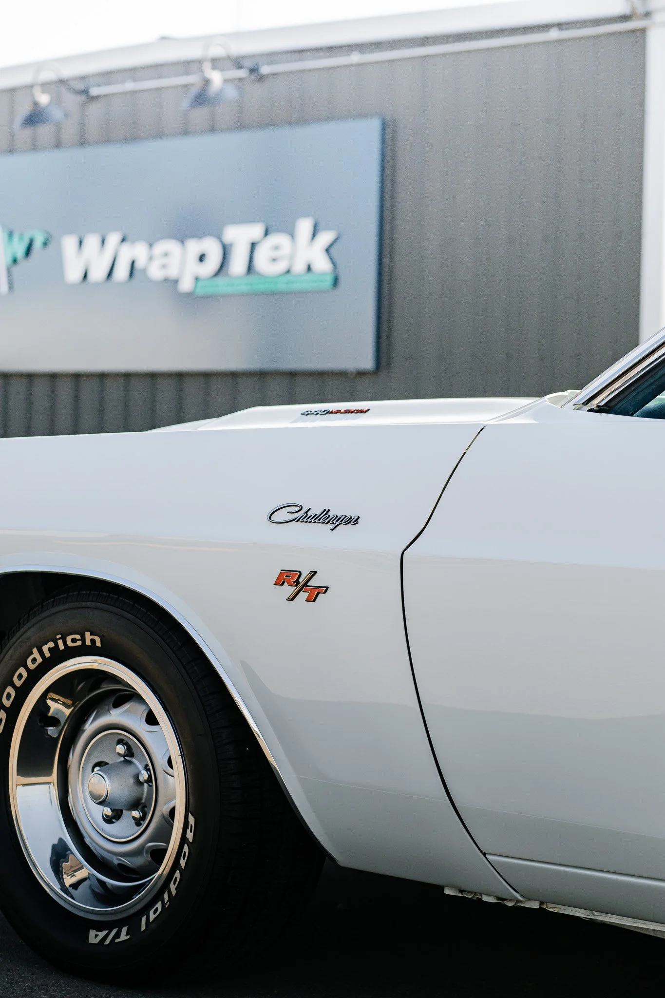 Close-up of a white Dodge Challenger R/T hood and fenders with paint protection film and ceramic coating in Hanna, Alberta.