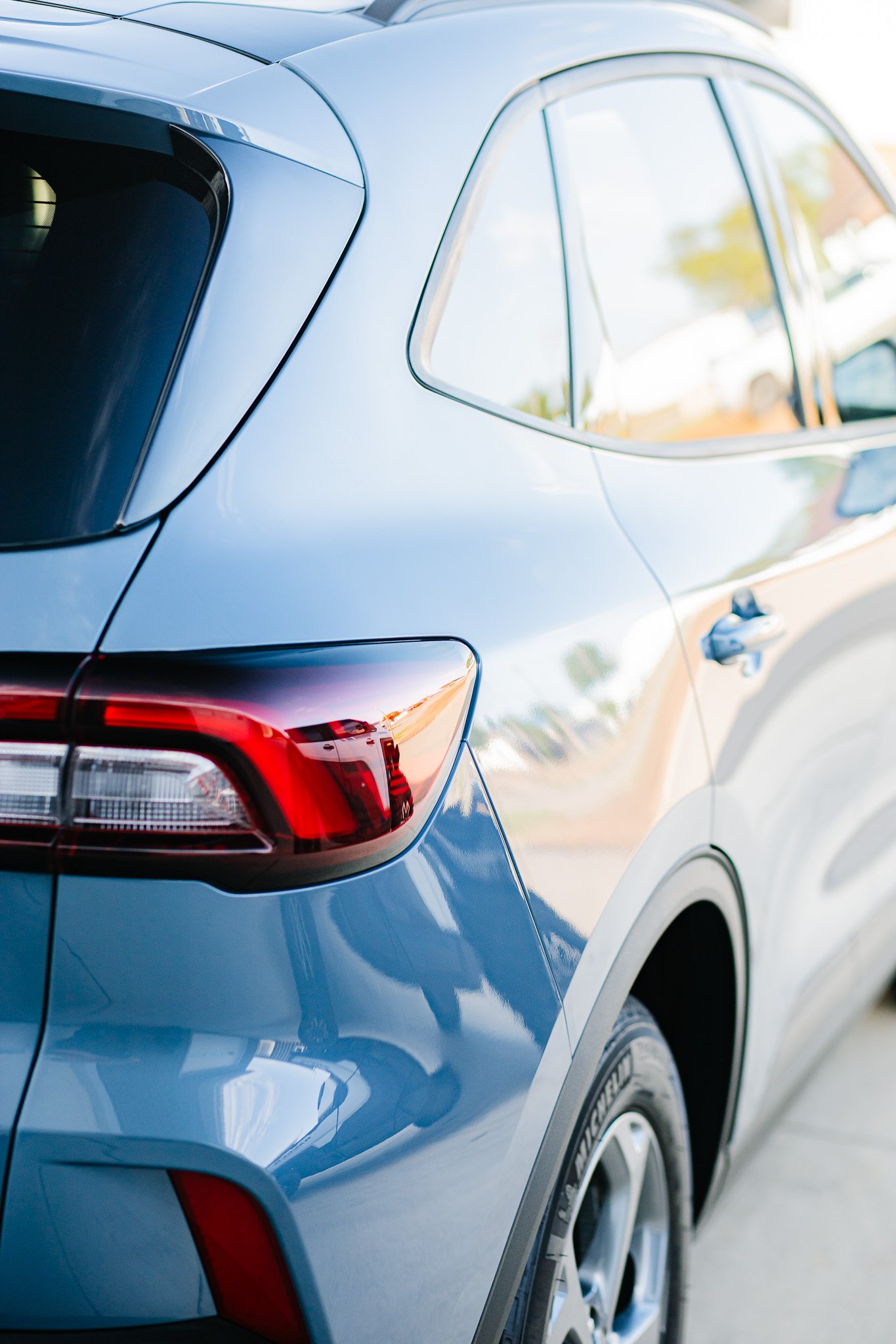 Close-up of the rear side of a modern Ford Escape SUV with paint protection film and ceramic coating in Hanna, Alberta.