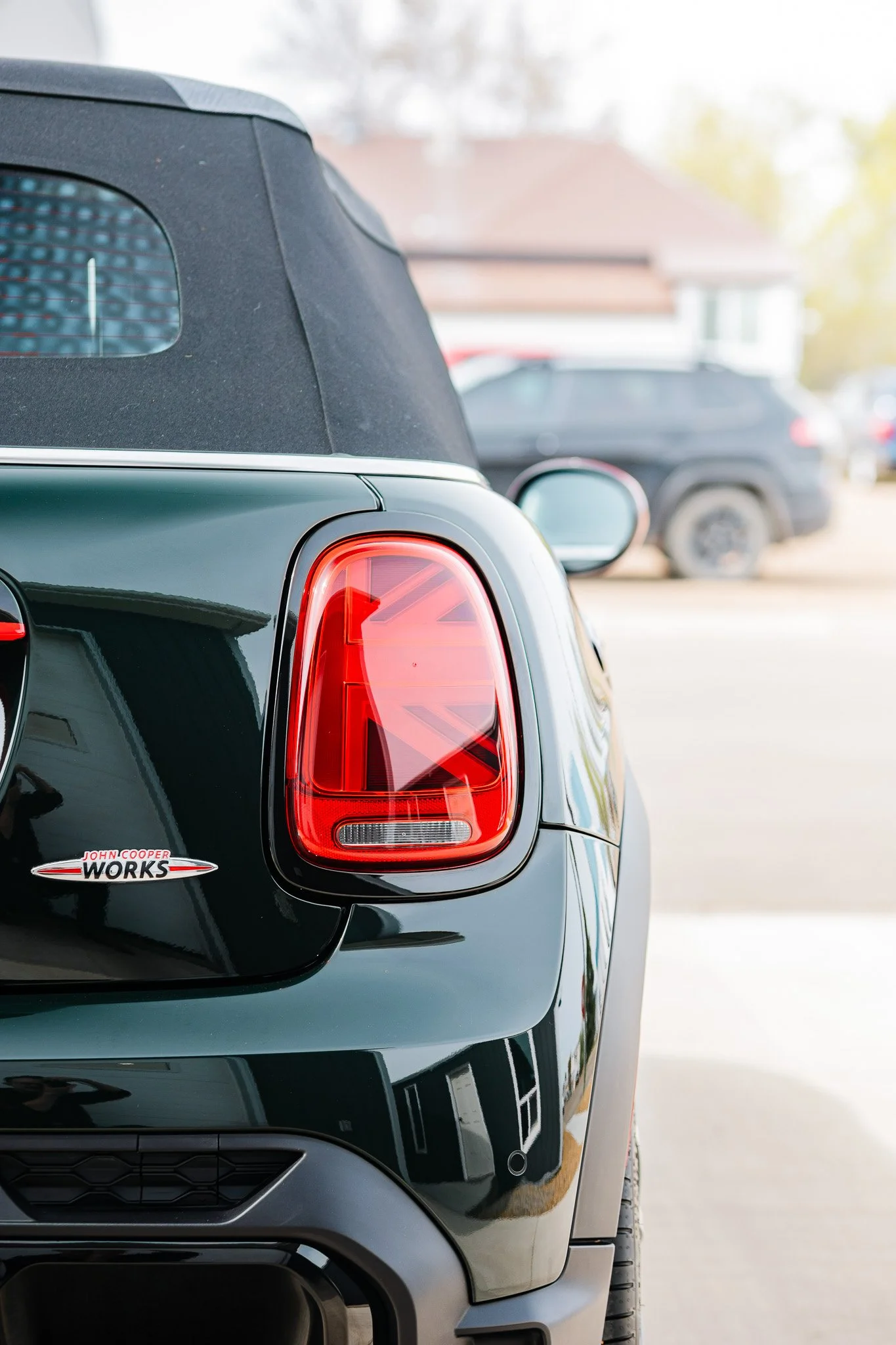 The rear view of a black Mini Cooper with paint protection film and a ceramic coating in Hanna, Alberta.