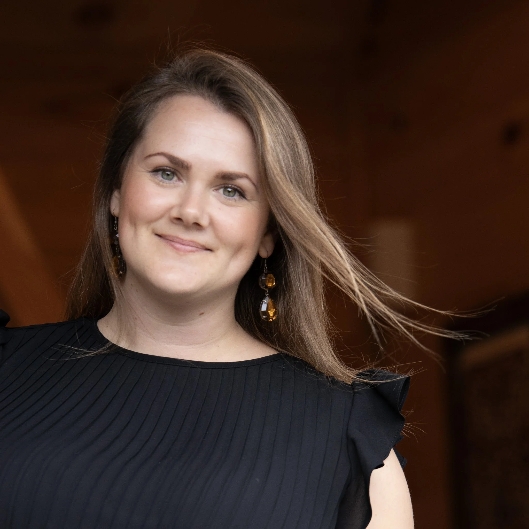 Marisa, smiling warmly, offering guidance as a body image and mental wellbeing coach