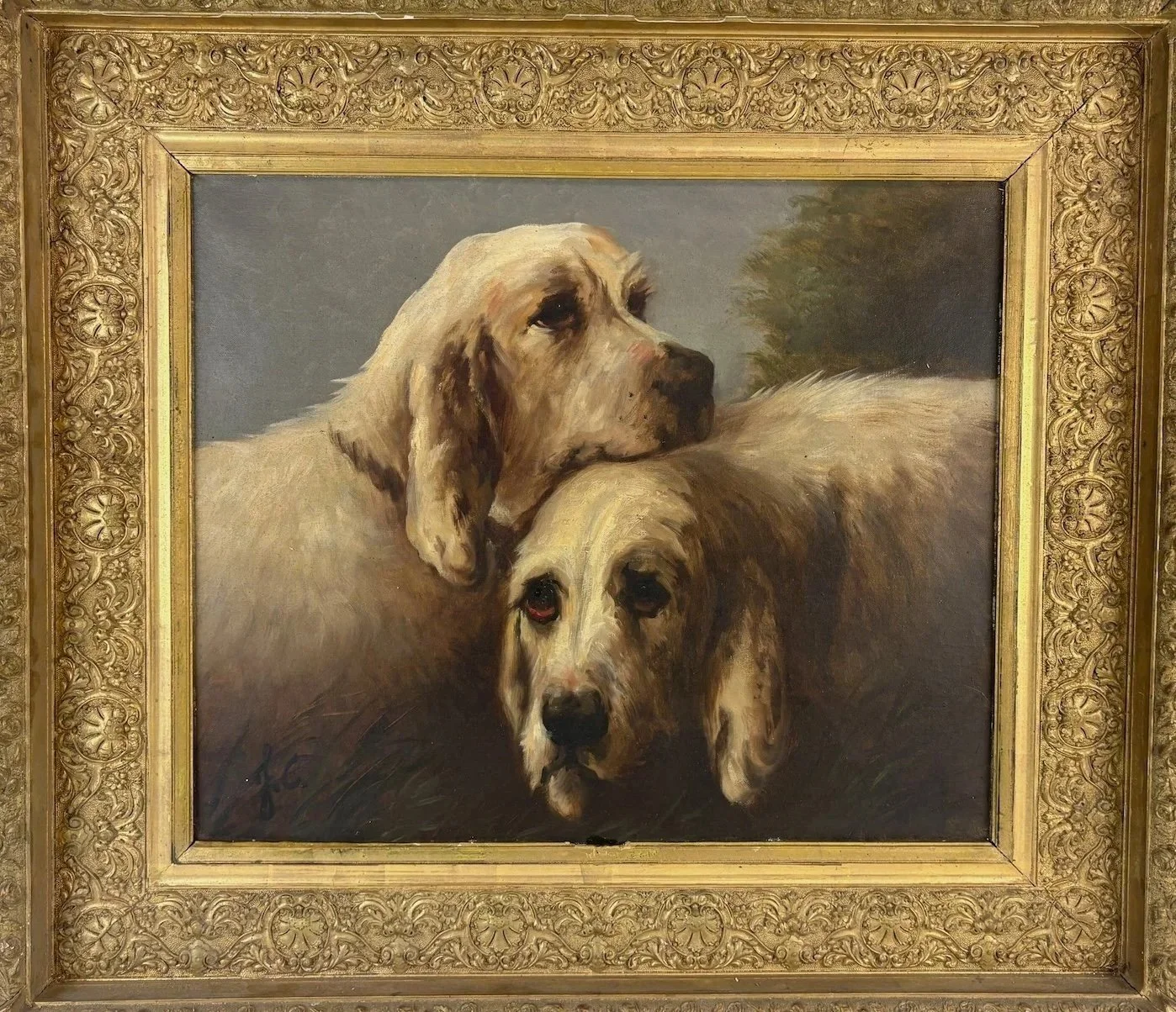 An early circa 1870 Jules Chardigny painting of dogs with one resting its head on the other's back, framed with a gold ornate frame.