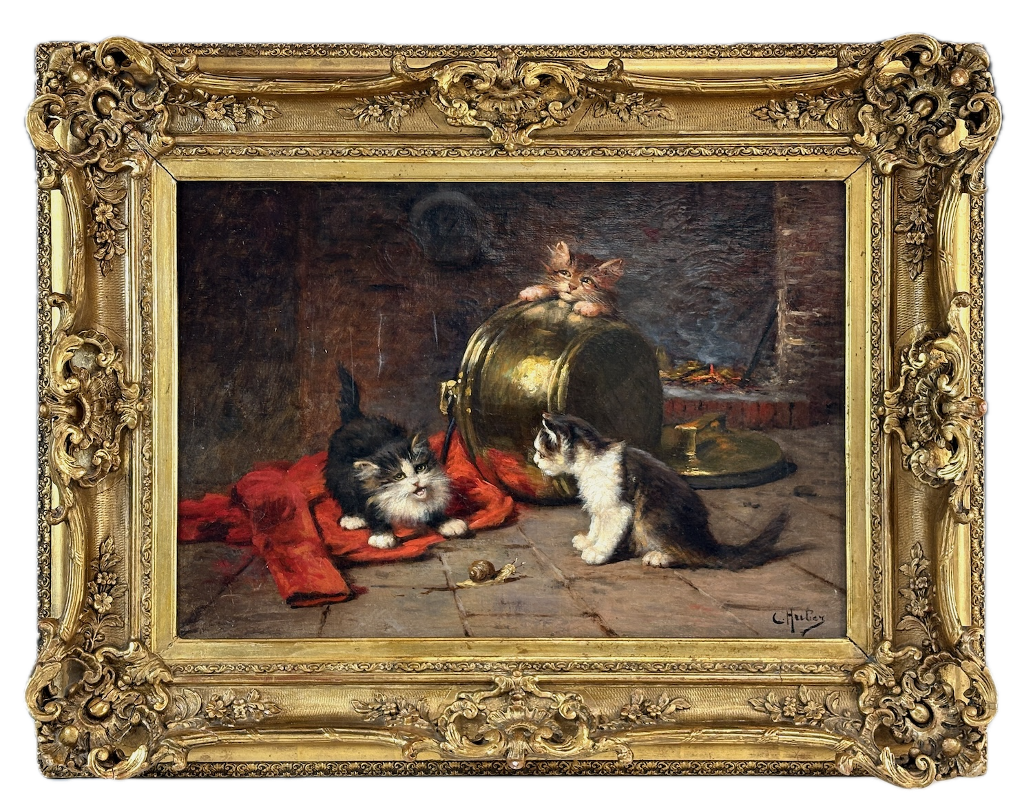 Oil painting of three kittens in a Victorian-style ornate gold frame. Two kittens are on a hardwood floor with one looking at a ball of yarn and the other sitting. The third kitten is peeking over a large metal container in the background, with a fire and dark interior behind them.