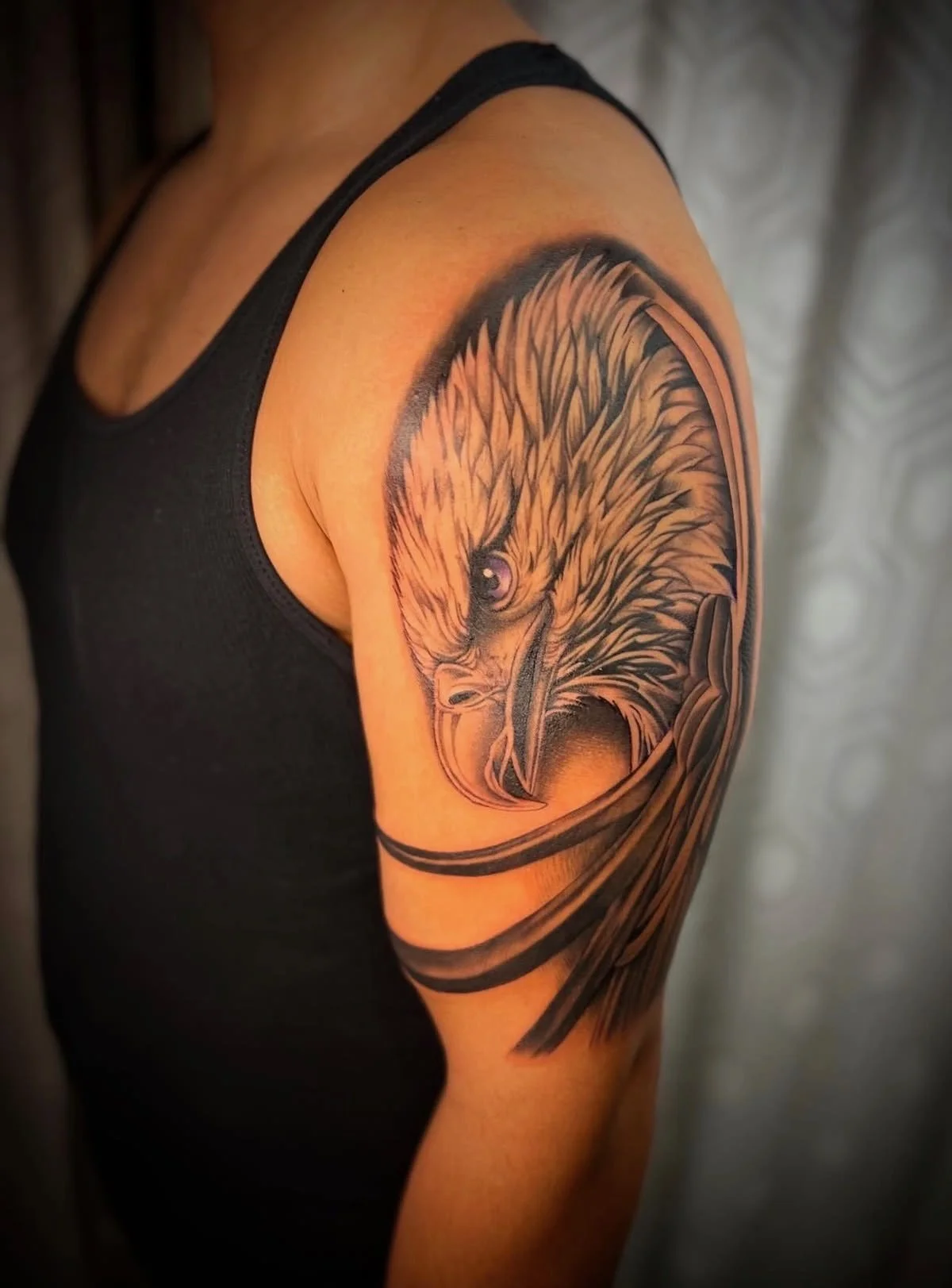 A tattoo on an arm of a black and grey realism eagle by portland tattoo artist at Upper Moon Tattoo, Daniel Aispuro