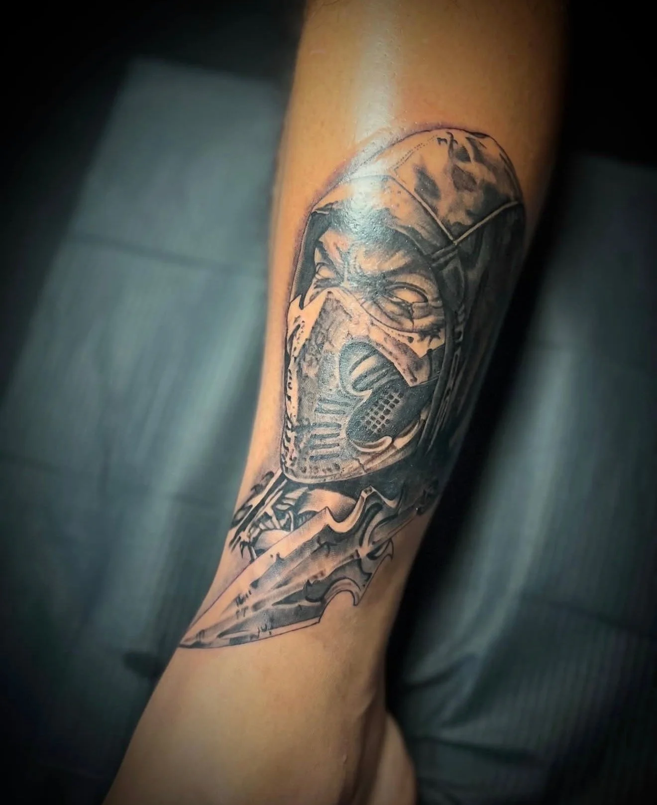 A black and grey realism tattoo on the forearm of Scorpion from Mortal Kombat by portland tattoo artist at Upper Moon Tattoo, Daniel Aispuro