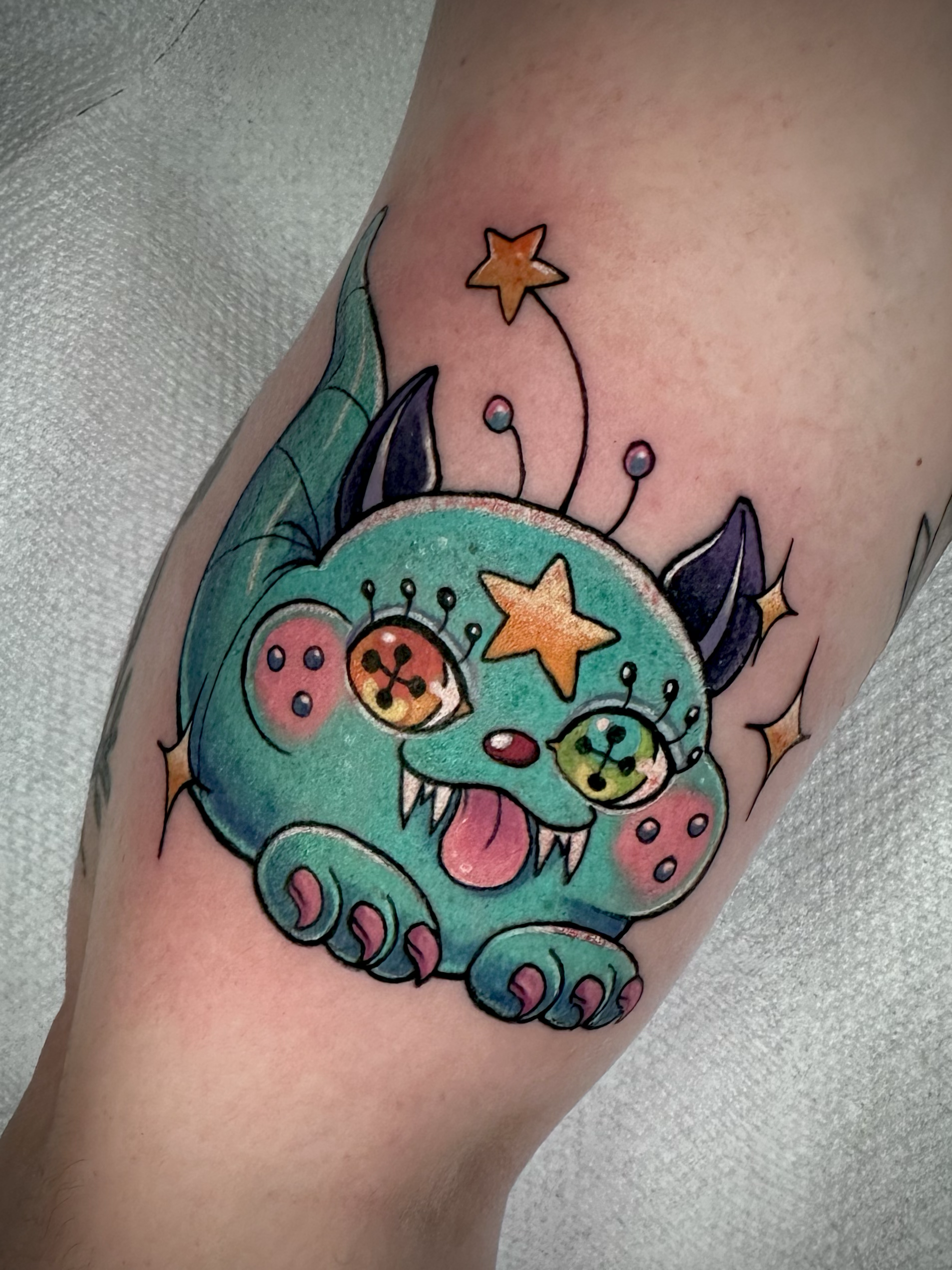 Custom color cute kawaii alien tattoo on the arm  by Portland Tattoo artist at Upper Moon Tattoo Rae Syndulla 