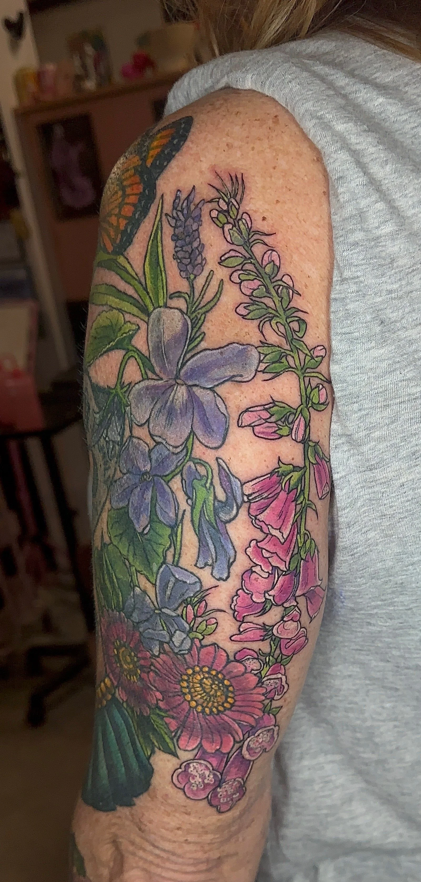 Color floral tattoo on the upper arm, half sleeve florals illustrative tattoo  by Portland Tattoo artist at Upper Moon Tattoo Rae Syndulla 