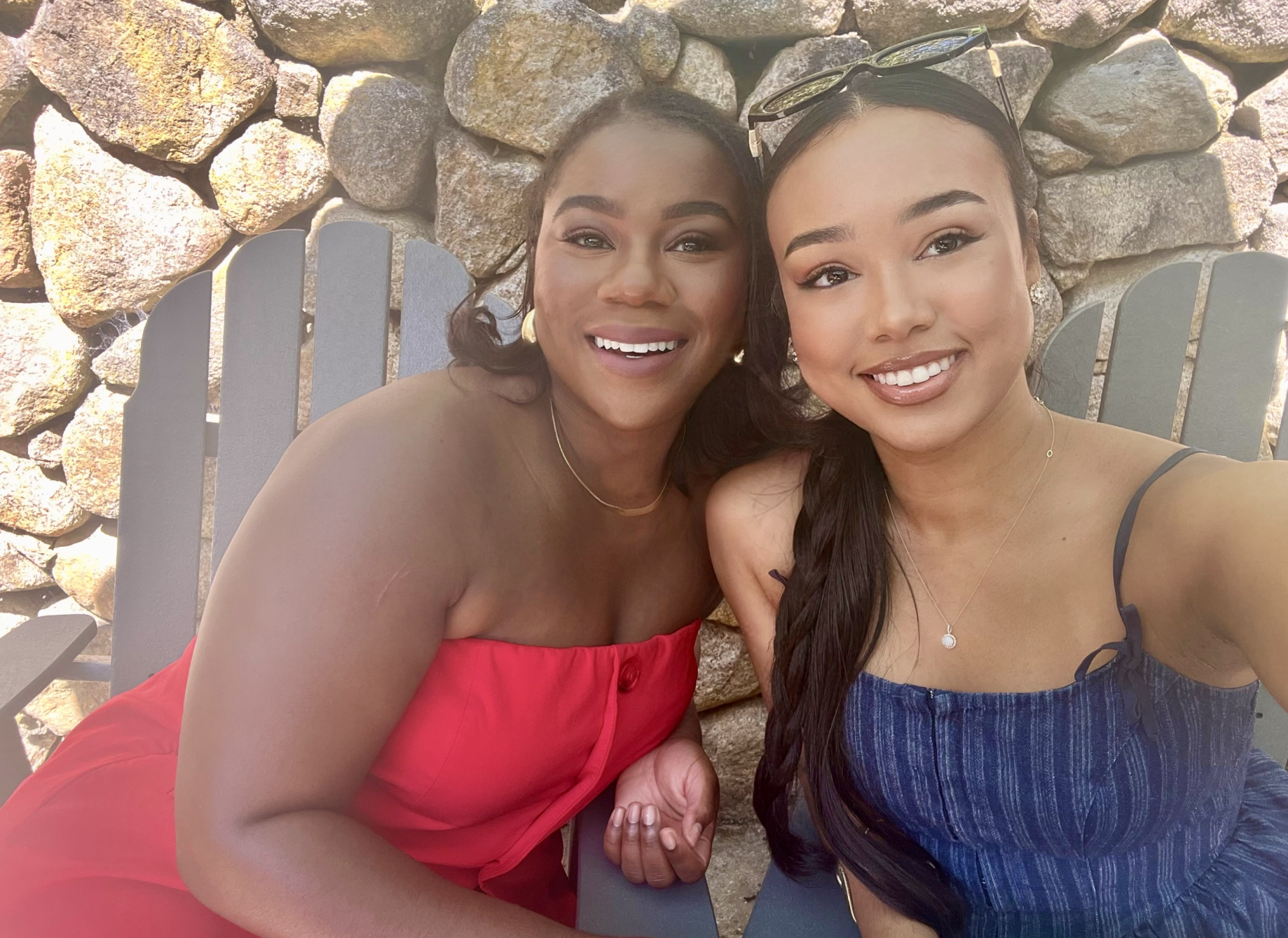 Selfie of Rachel Gray from That Martech Girl and Bria Porter sitting in chairs. A stone wall is in the background