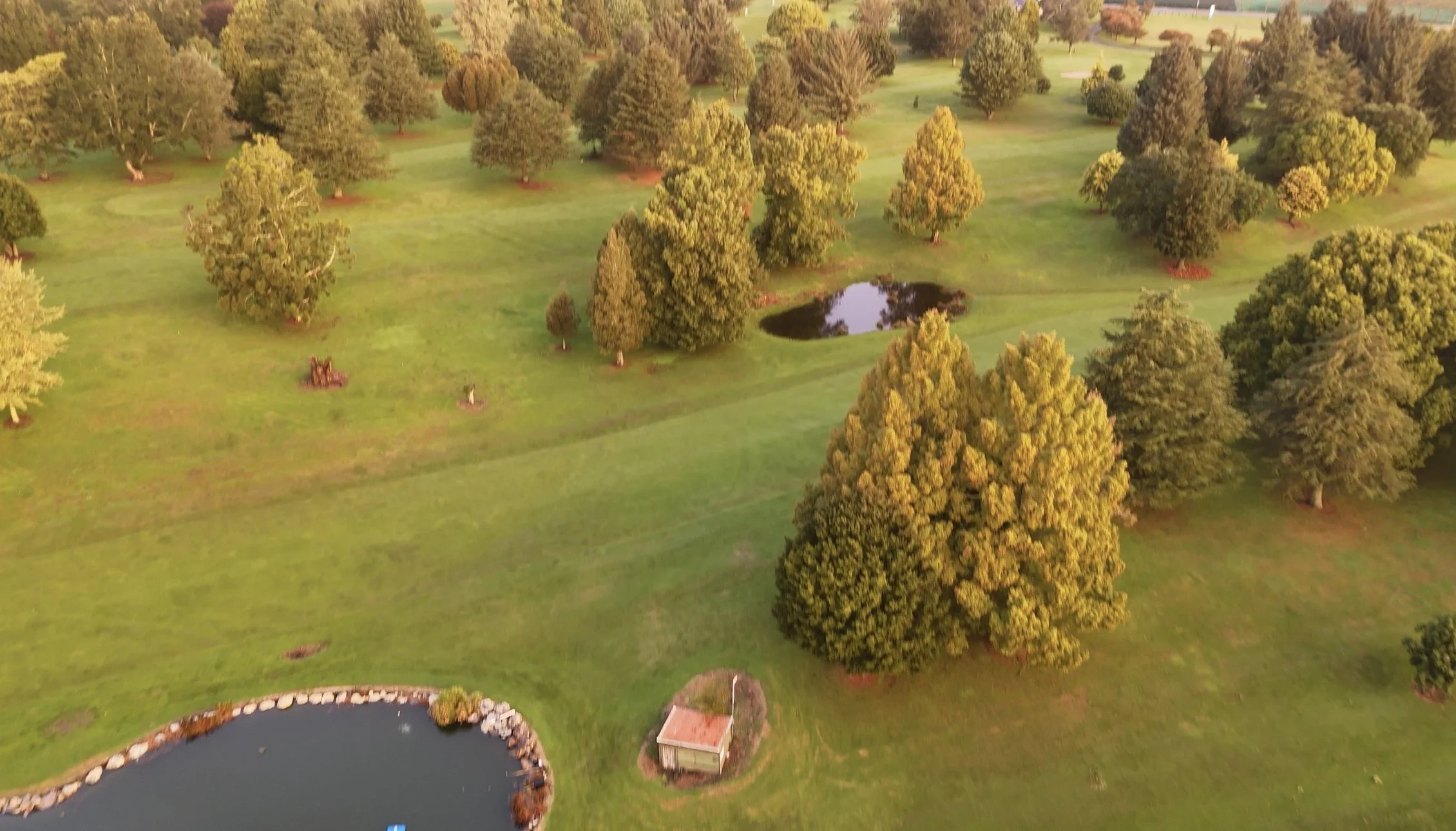 Arial view over looking the 18th fairway at Te Puke Golf Course with ponds guarding the left and right sides 