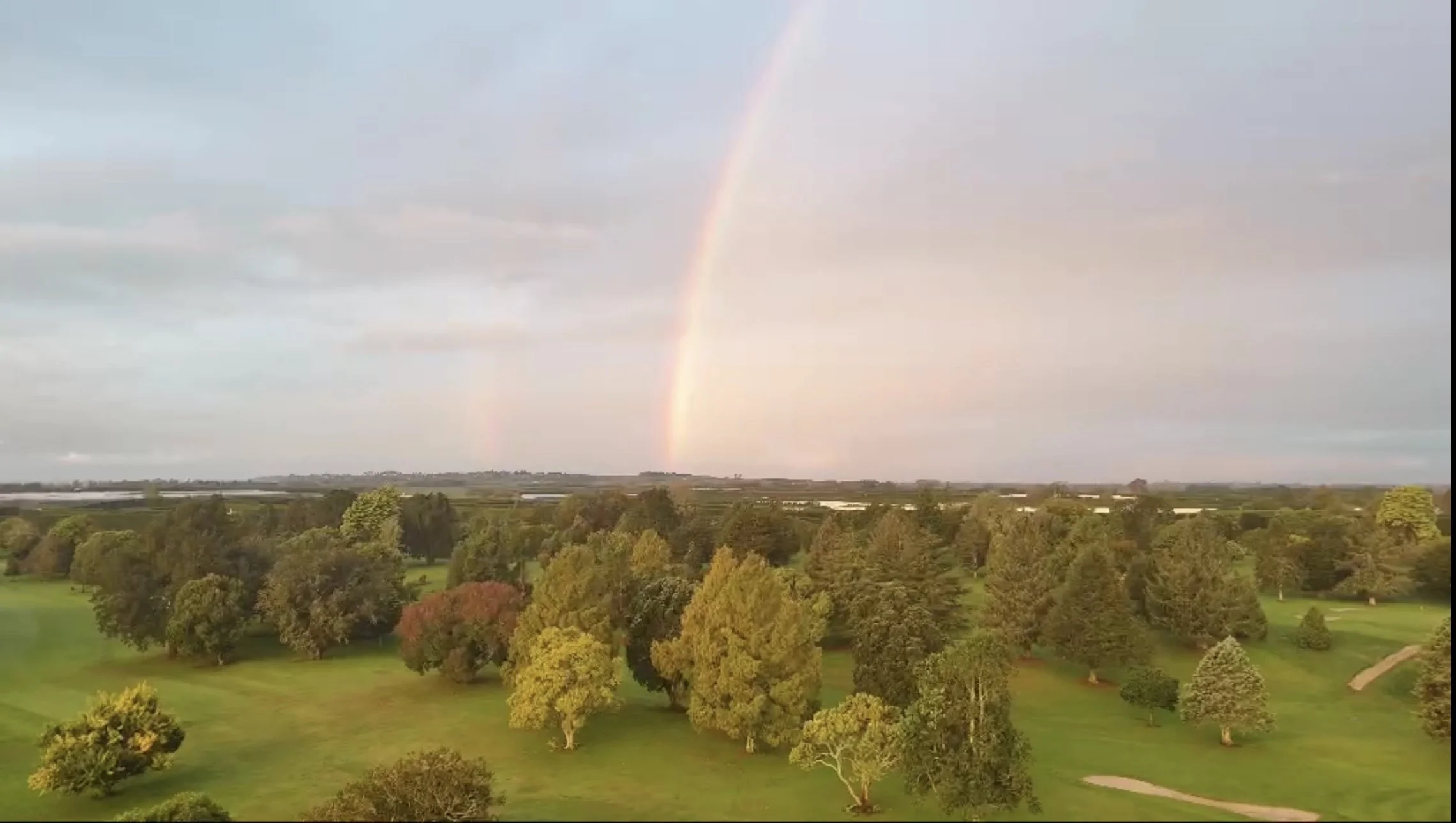 Arial fly-over at Te Puke Golf Course with a rainbow in the distance.