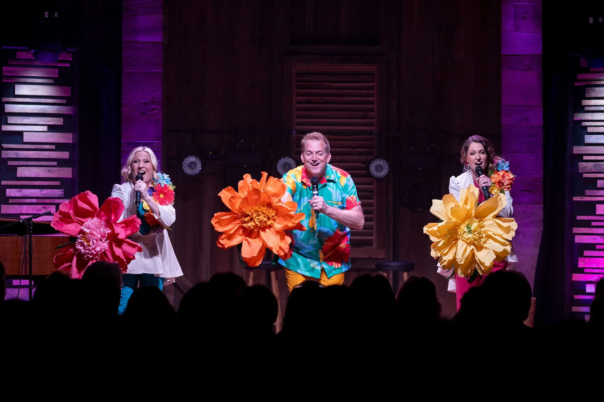 3 singers with flowers performing