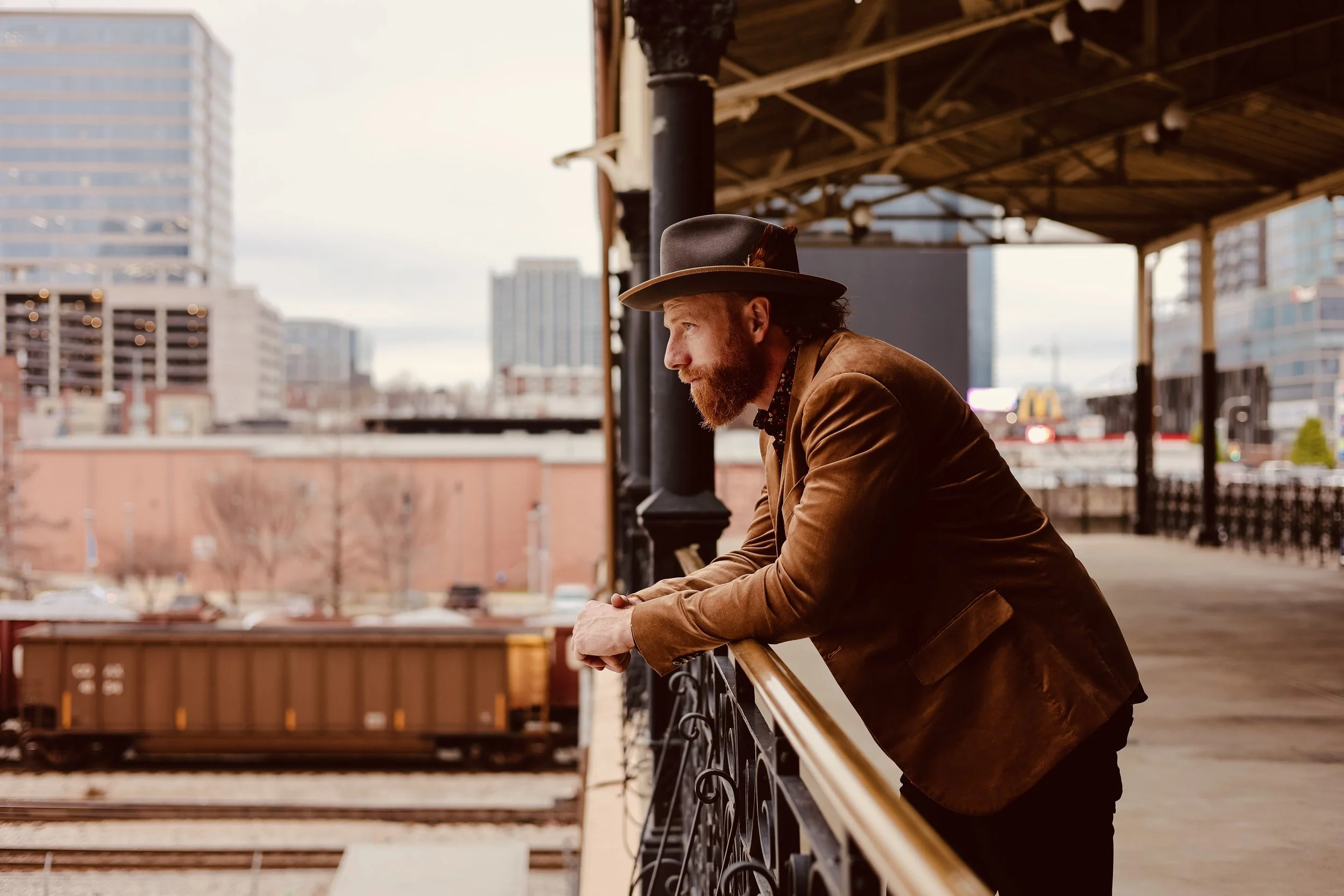 Matt Papa looking over railing at trains