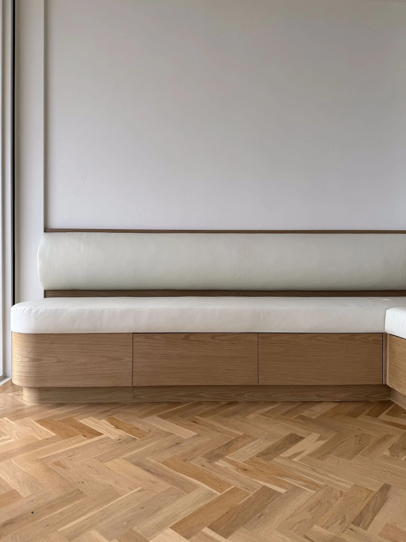 Close-up of light wood cabinetry with smooth, matte grey stone benchtop highlighting craftsmanship details - expertly crafted joinery by Repose Sydney.