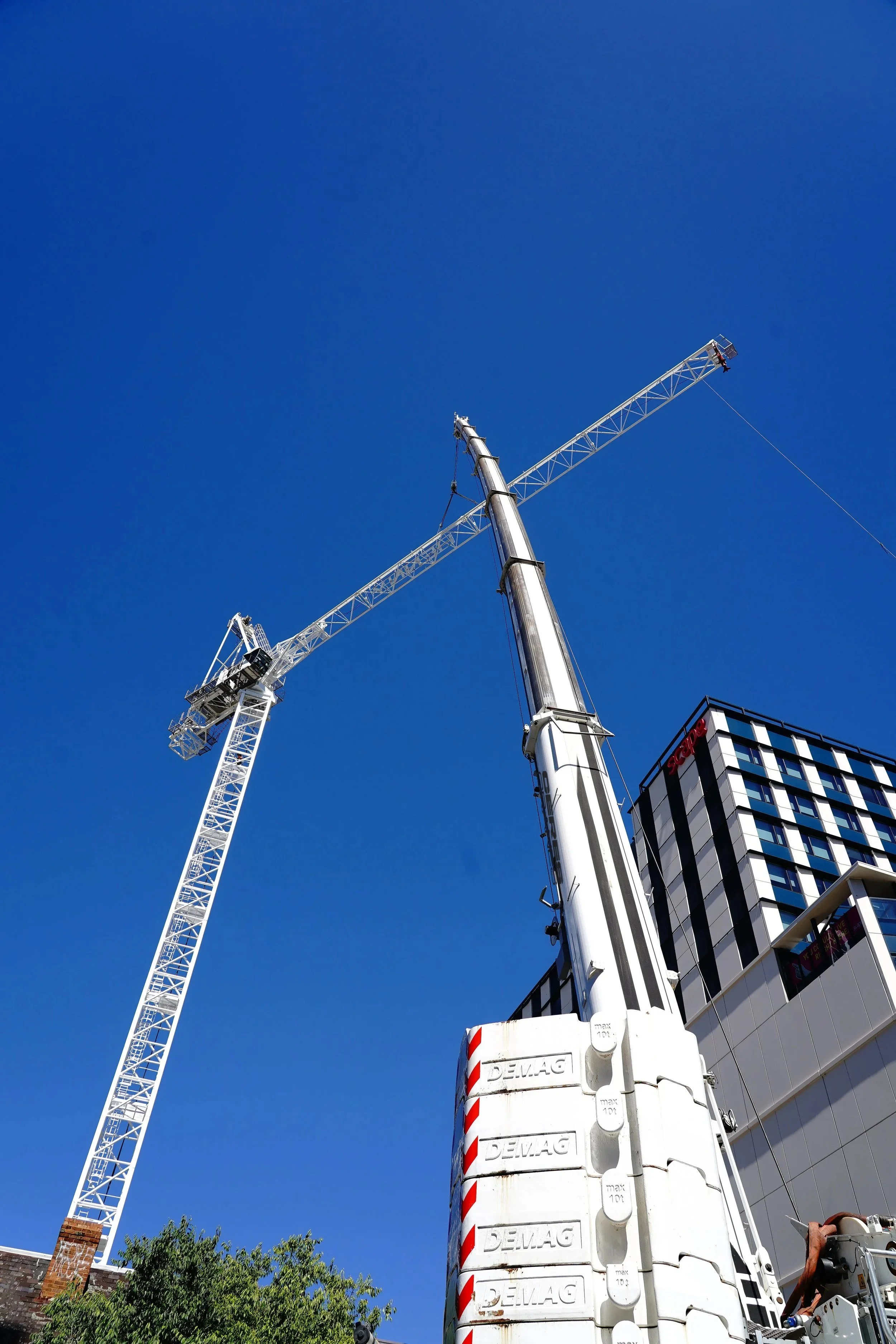 450T Tadano Demag crane working near a tower crane