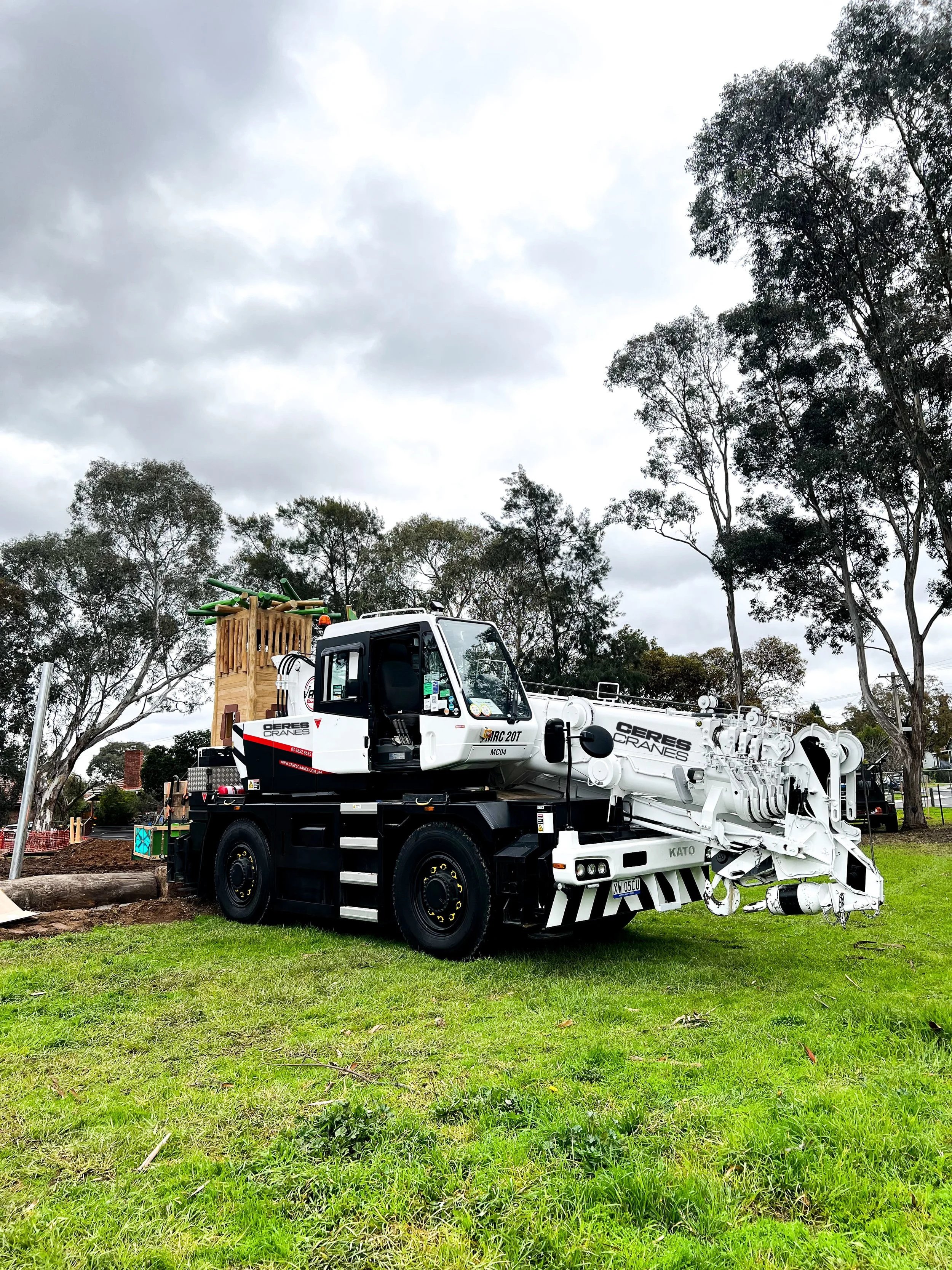 Ceres Cranes 20T Kato city crane set up on grass among gum trees
