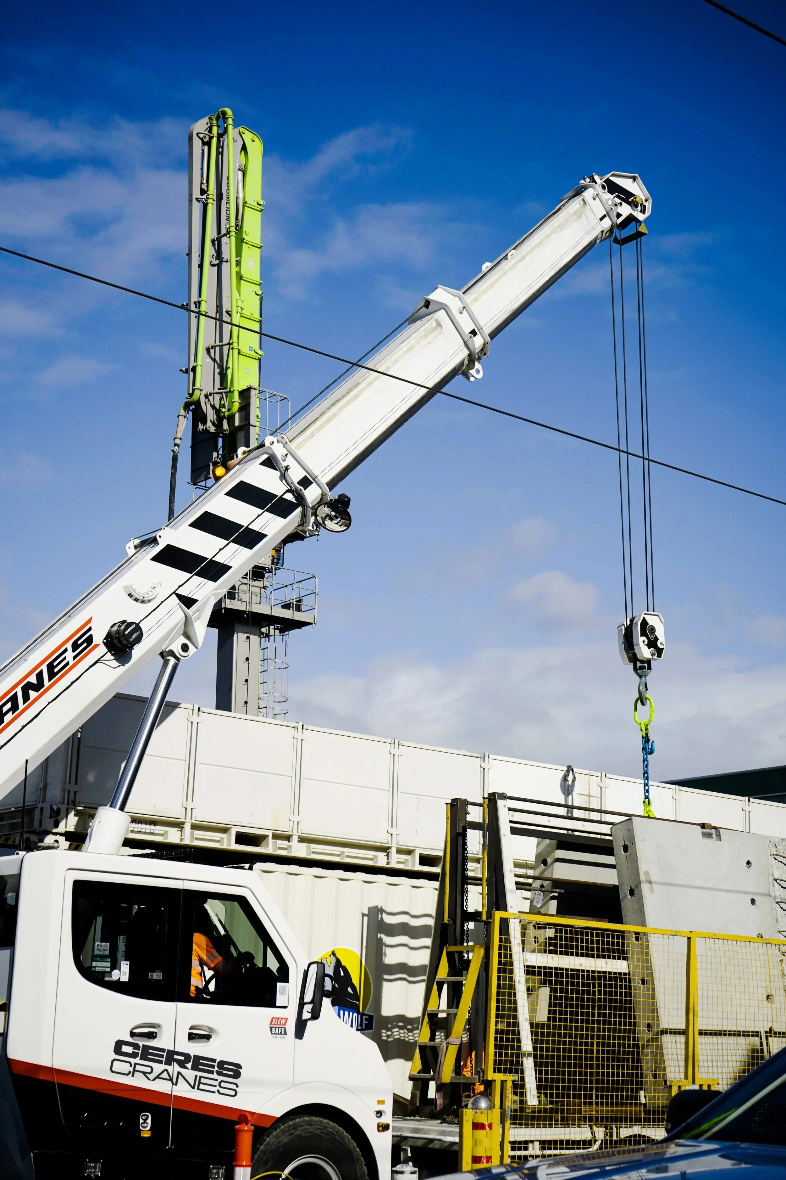 Ceres Cranes 28T TIDD pick and carry crane lifting beside scaffolding