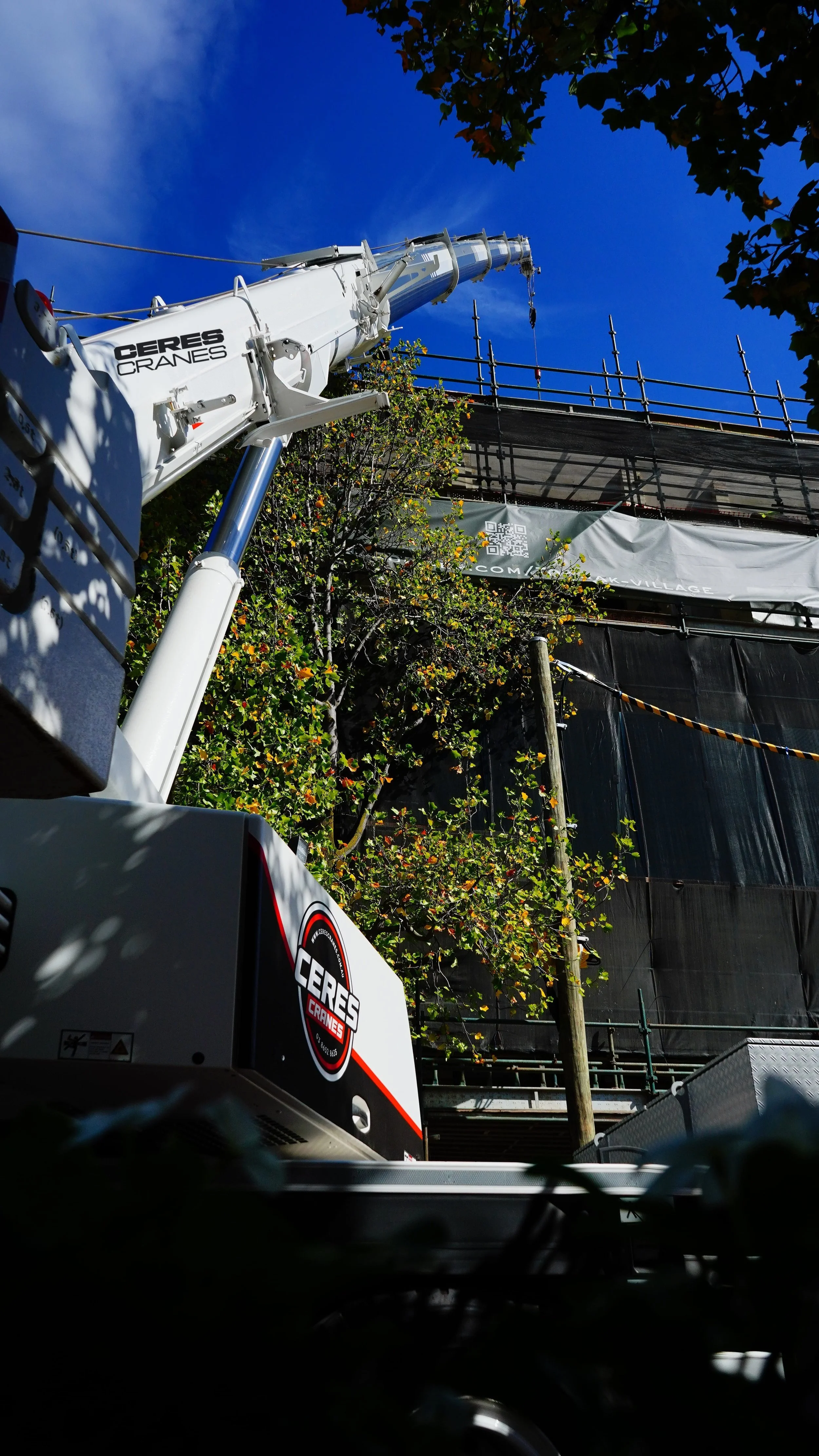 Ceres Cranes 60T Liebherr boom raised among trees