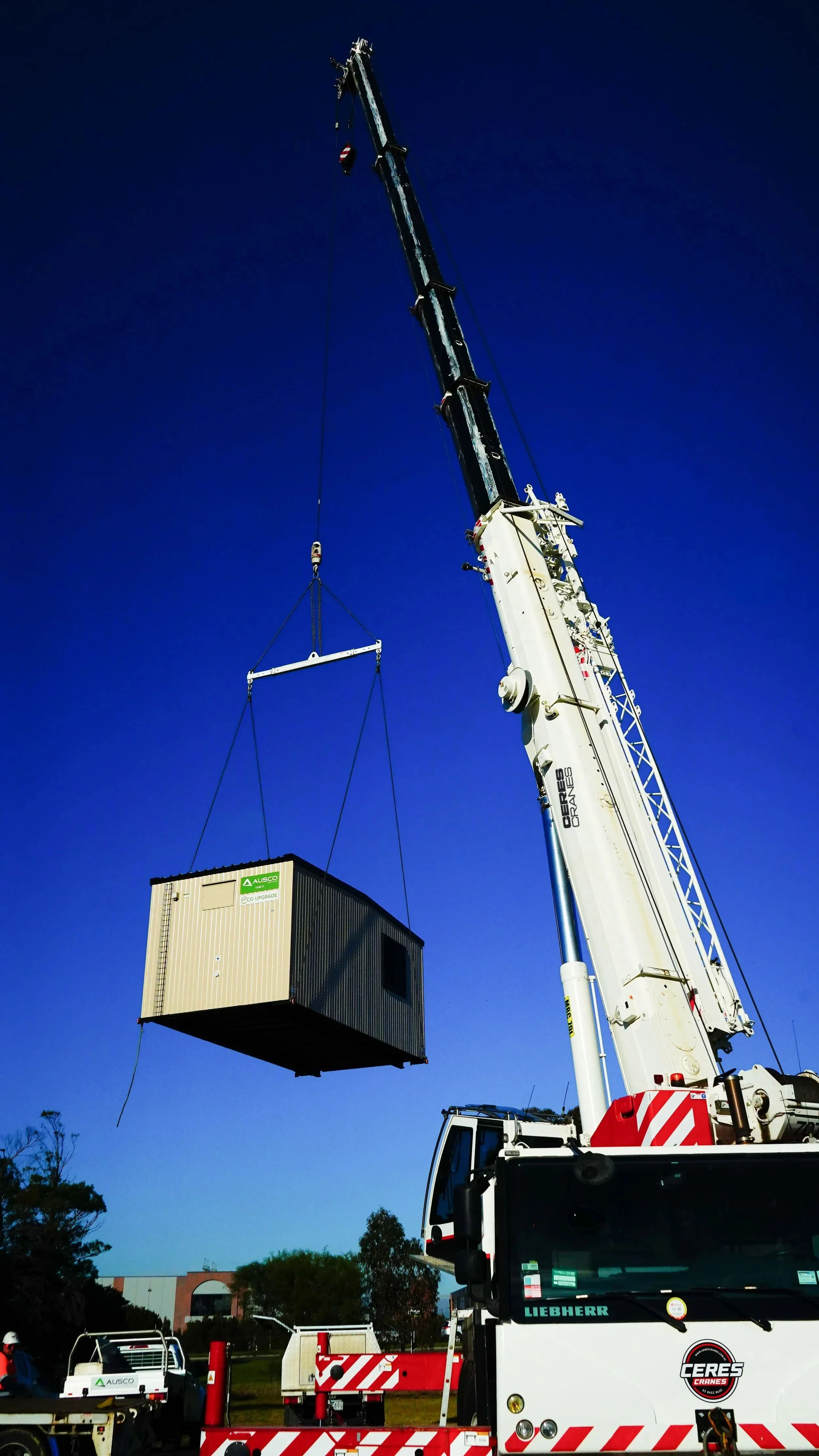 Ceres Cranes 70T Liebherr lifting a portable building