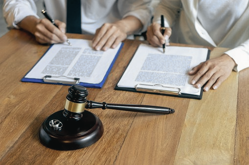 mobile-notary-two-people-signing-legal-documents-depositions-custody-battle-adoption-paperwork.png